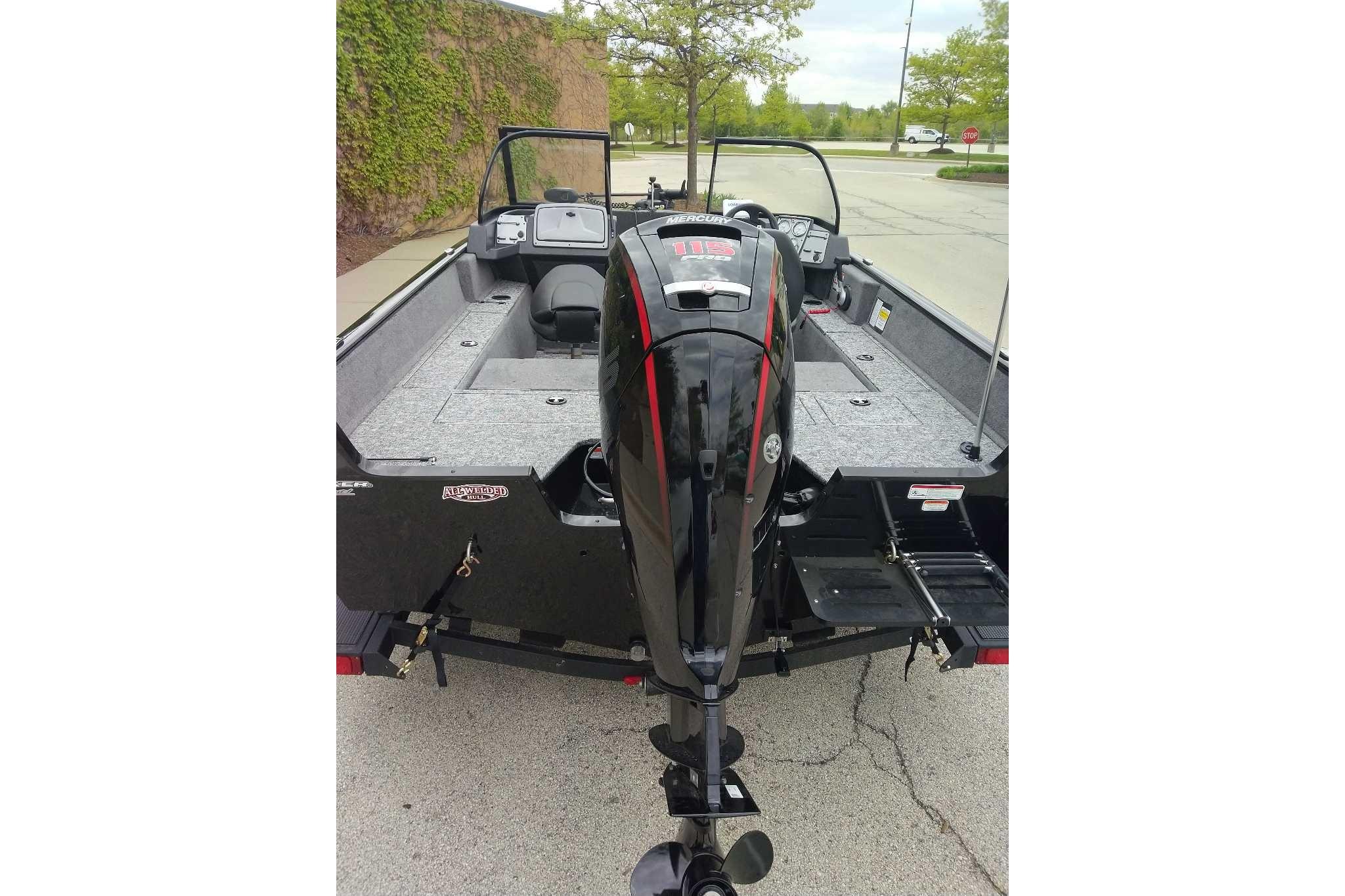 2026 Tracker Pro Guide V-175 Combo boat with powerful outboard motor, parked outdoors.