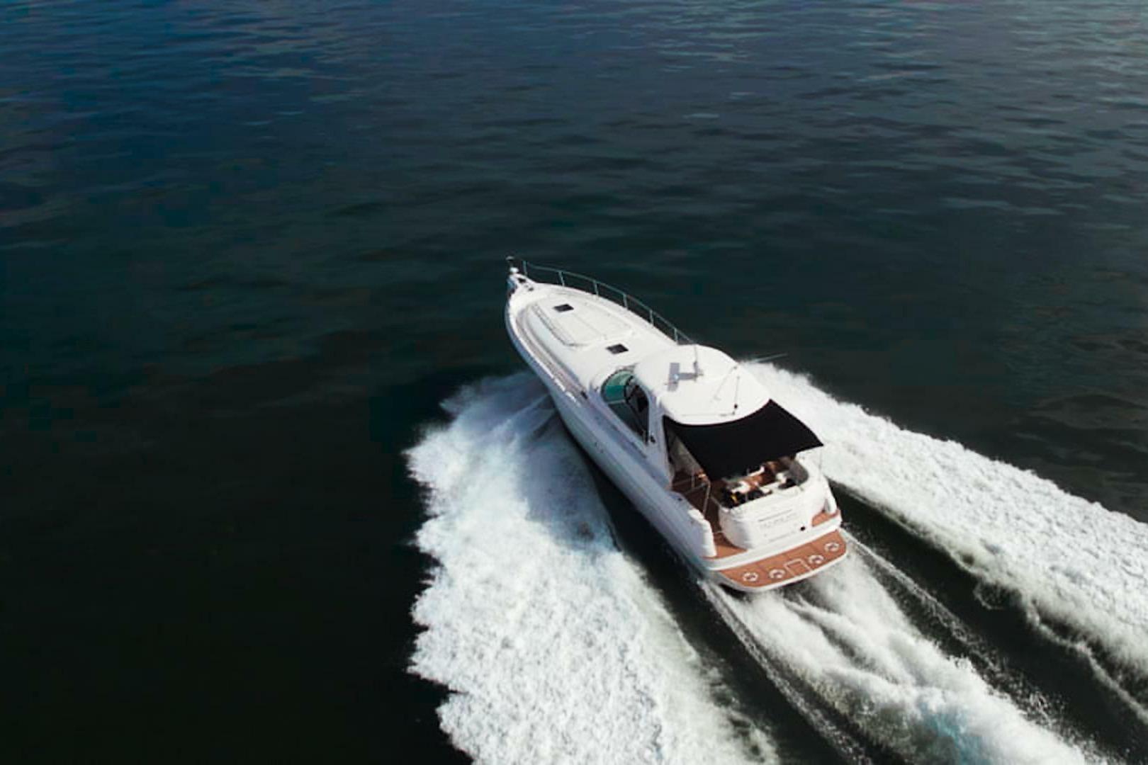 Aerial view of 2003 Sea Ray Sundancer 460 yacht cruising on open water.