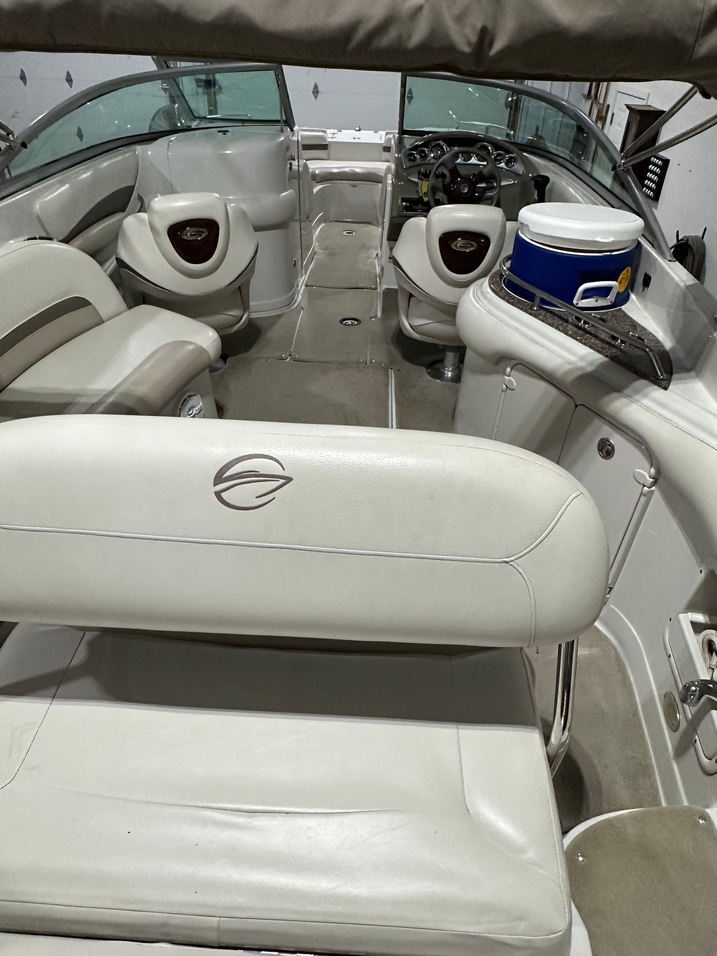 Interior of a 2007 Crownline 252 EX boat with white seating and a helm console.