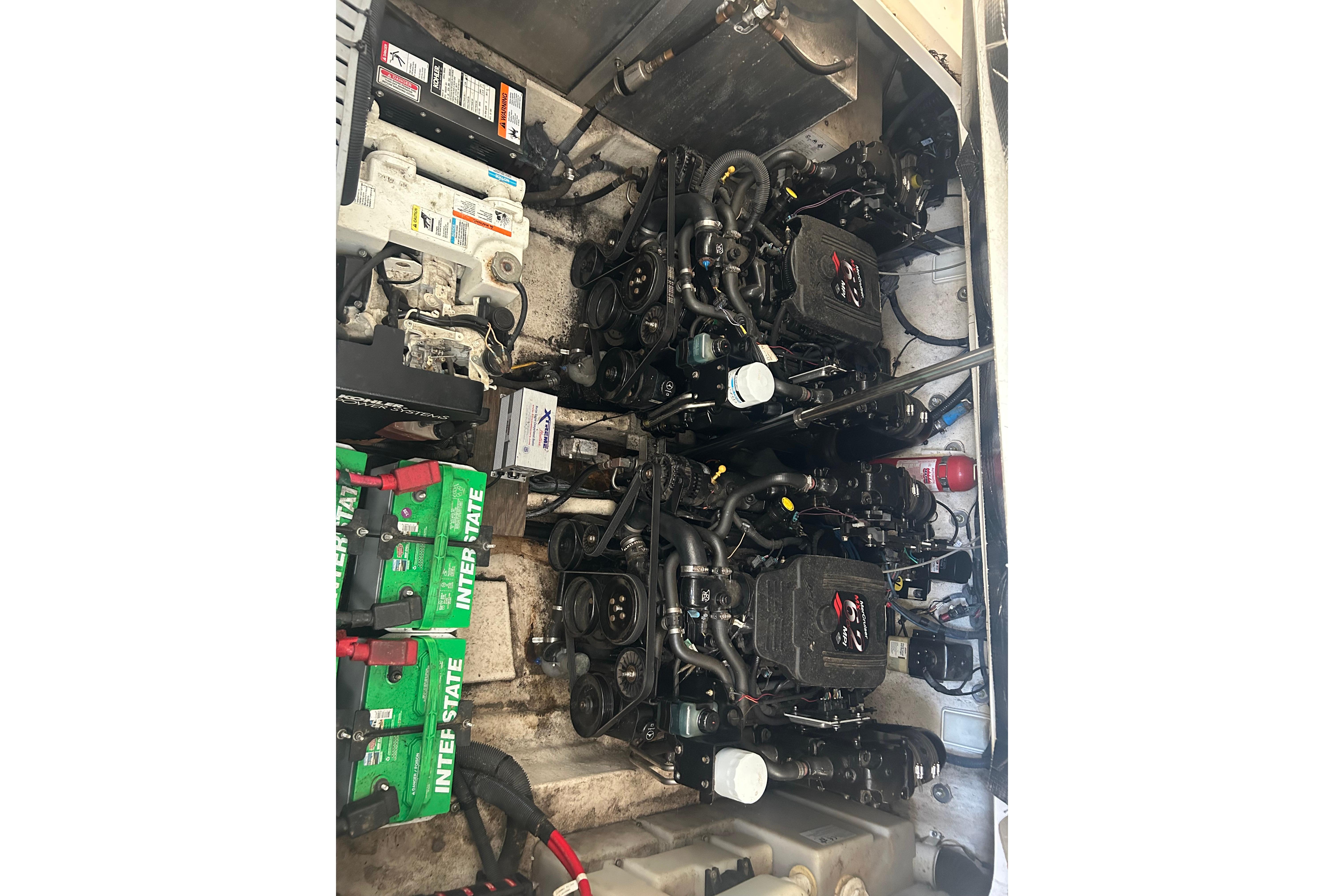 Engine compartment of a 2005 Sea Ray 300 Sundancer with visible batteries and components.