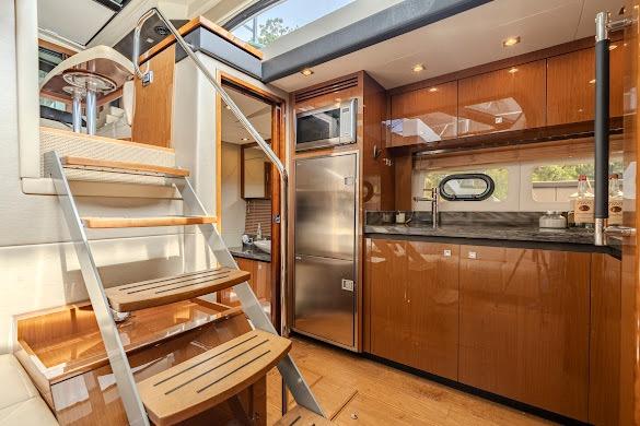 Luxurious interior of 2016 Sea Ray Sundancer 510 yacht with modern kitchen and staircase.