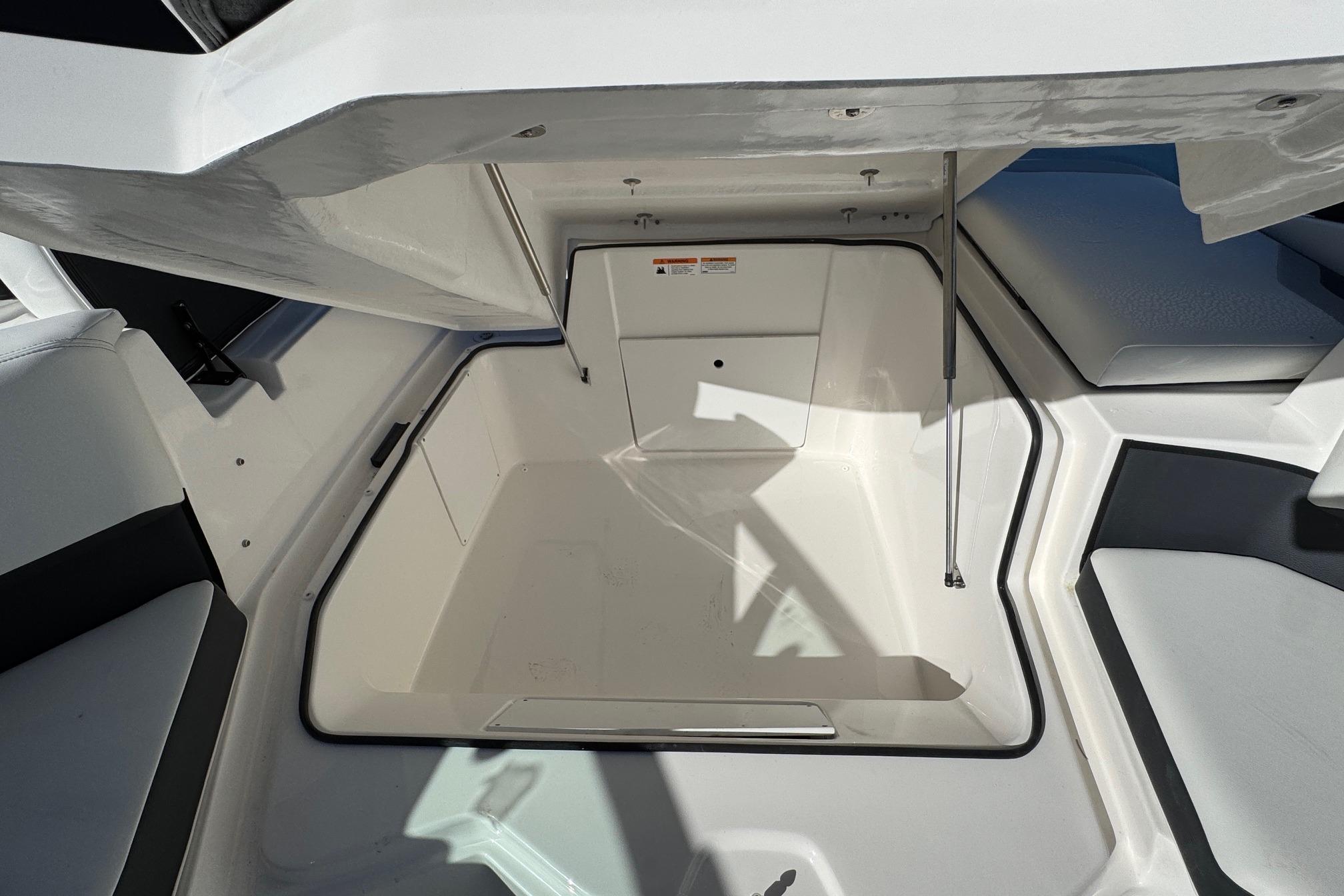 2026 Regal 21 OBX boat storage compartment with open hatch, showcasing spacious interior design.