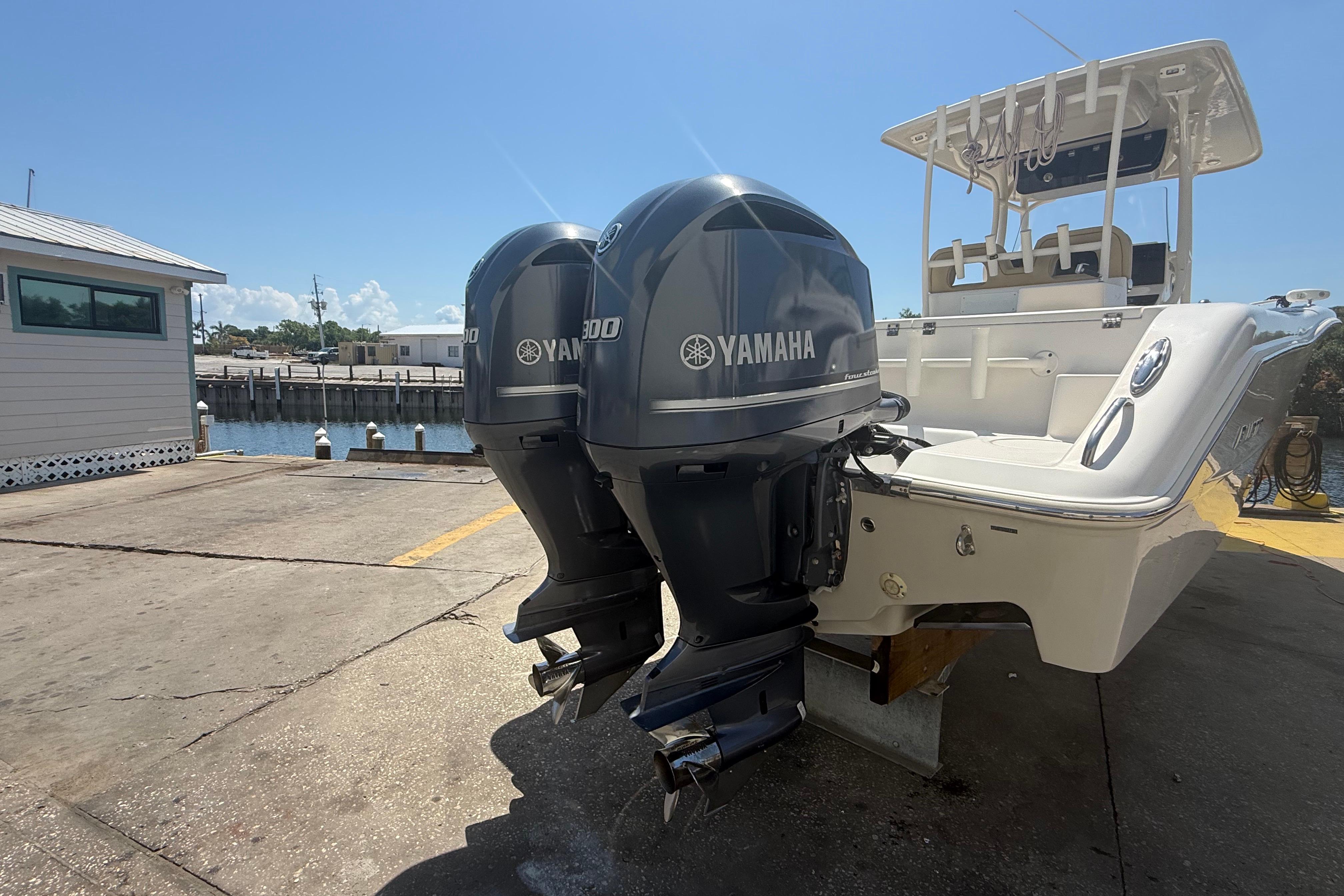 2019 Key West Billistic 281 Center Console with twin Yamaha outboard motors at dock.