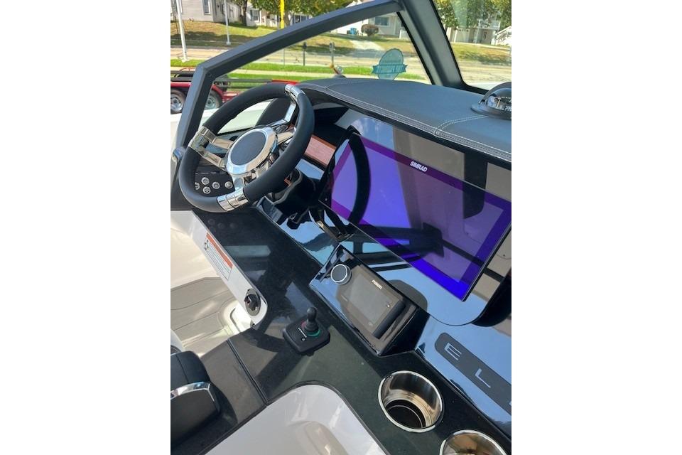 Cockpit of 2026 Monterey Elite 27 SD boat with modern steering and navigation display.