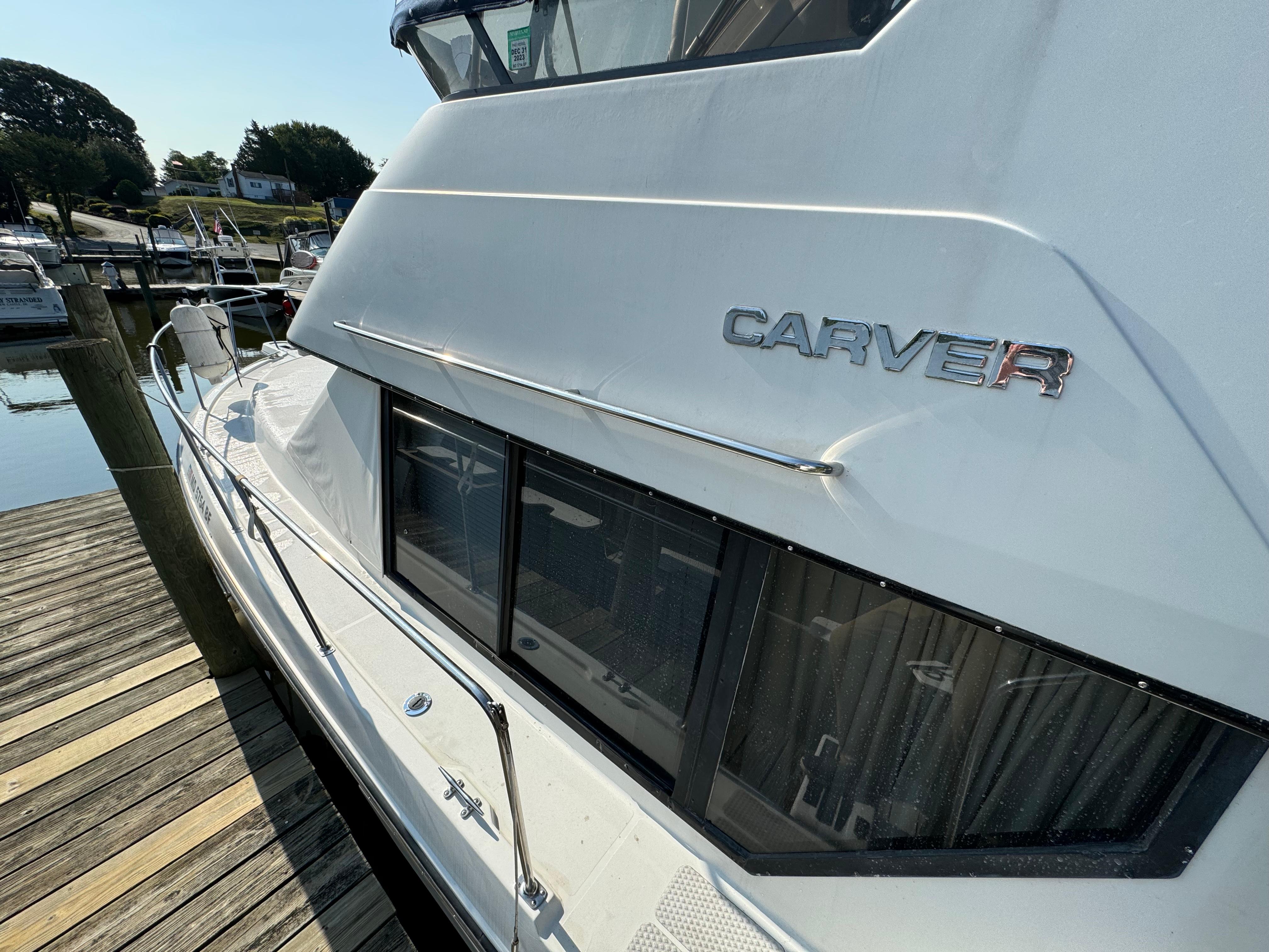 1991 Carver 33 Aft Cabin yacht docked, showcasing sleek design and windows.