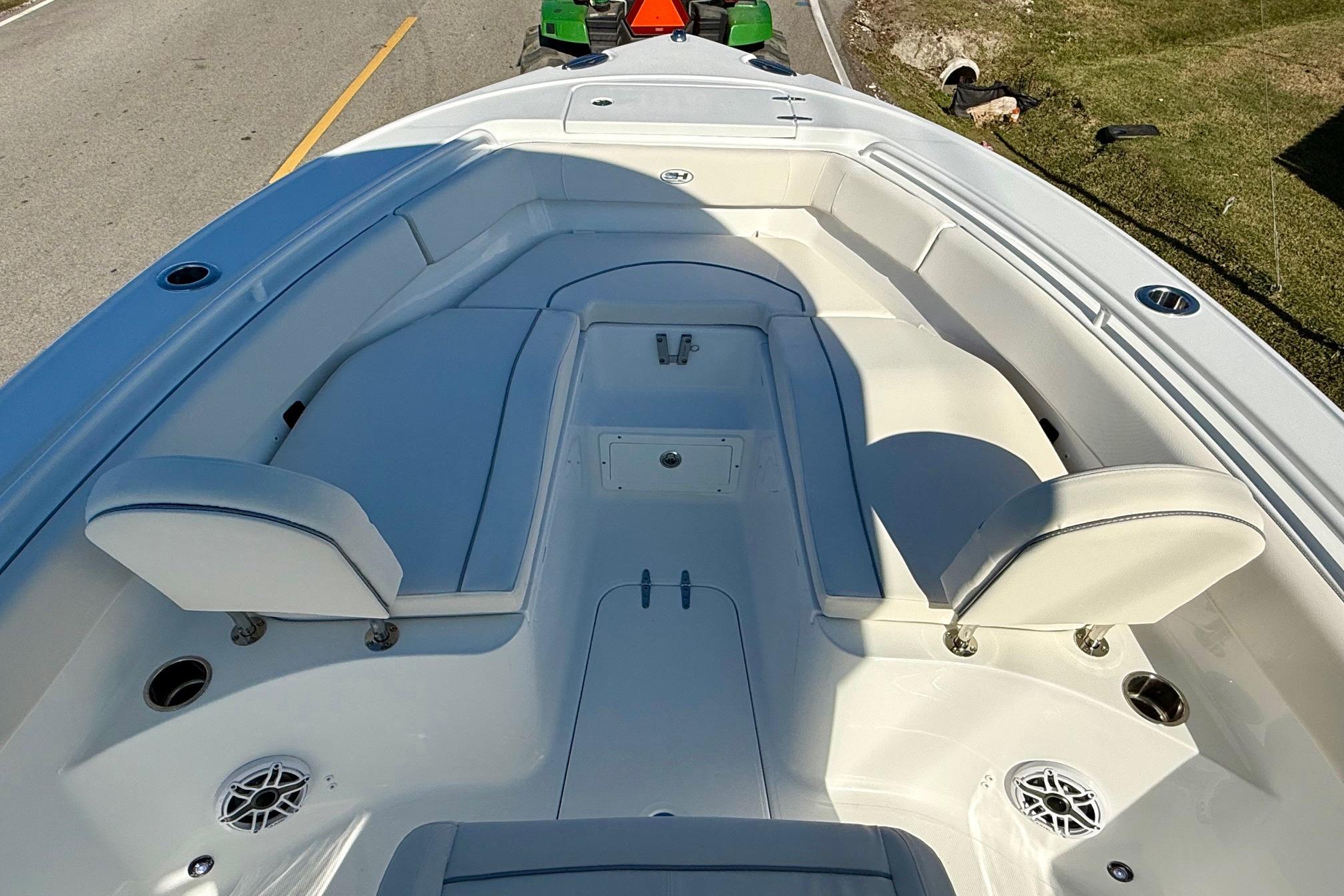 2026 Sea Hunt Ultra 255 SE boat interior with white seating and speakers.