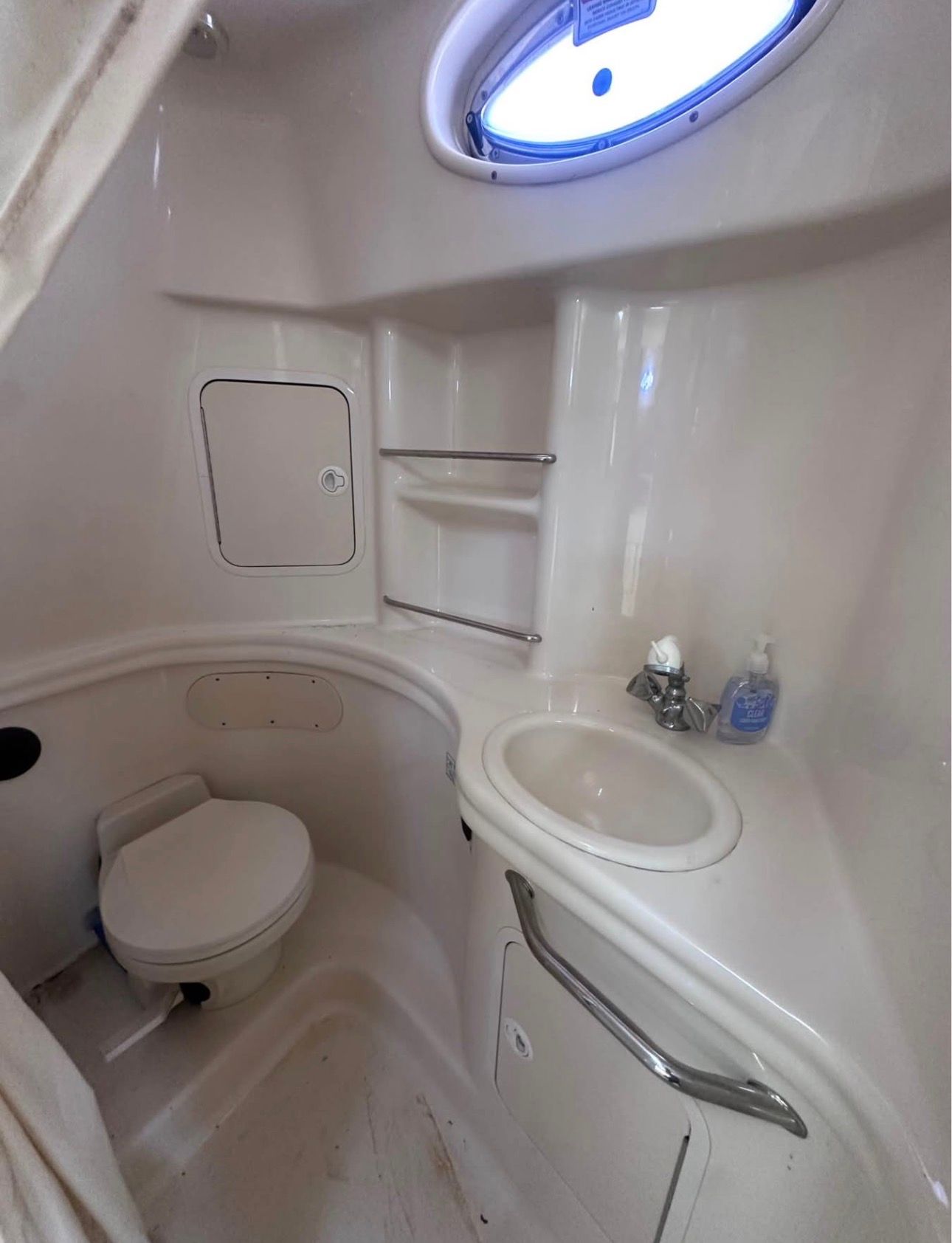 The image shows the bathroom of a 2002 Sea Ray 300 Sundancer.