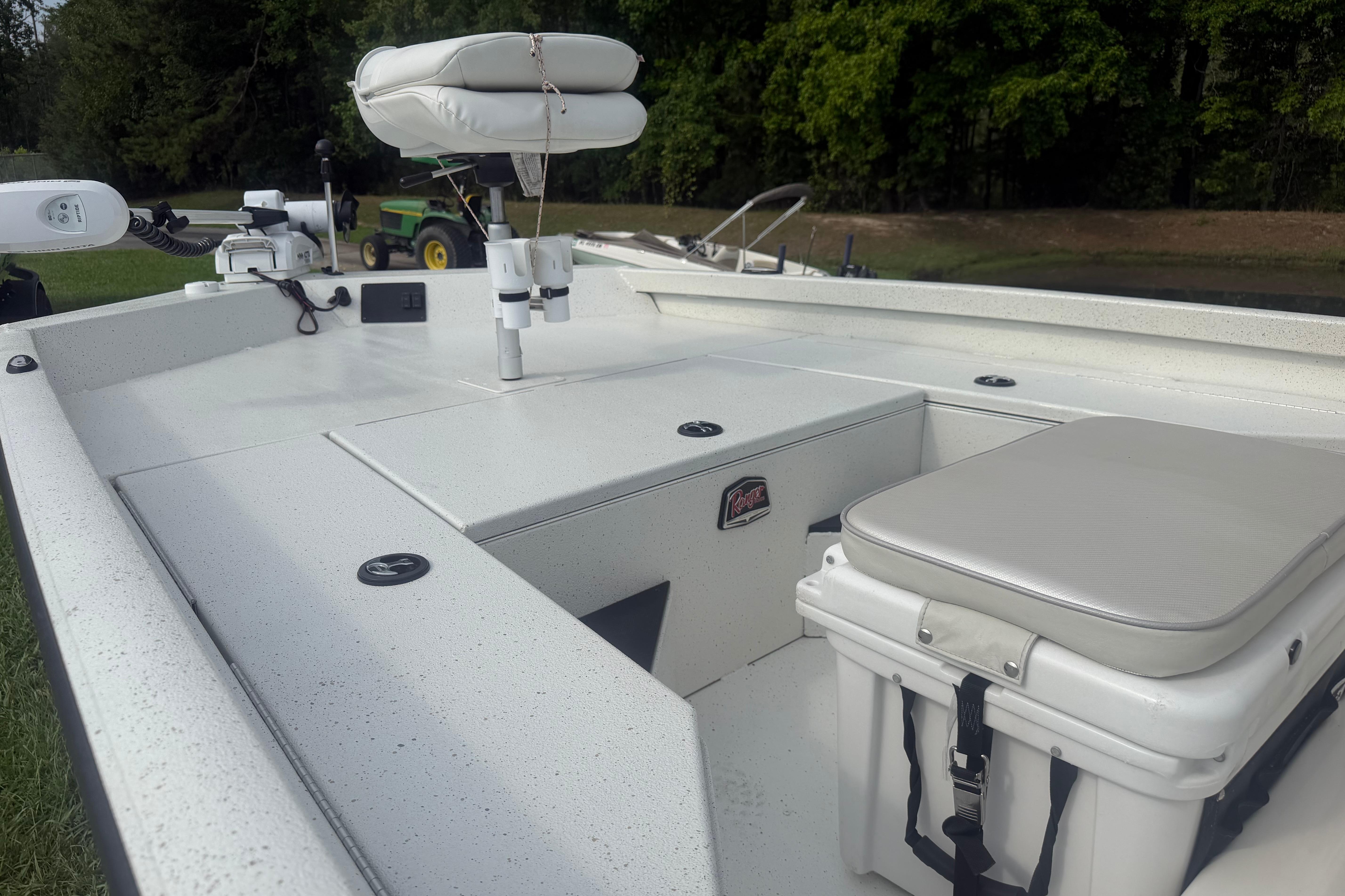 2018 Ranger RB190 boat interior with seating and storage, set in a grassy outdoor area.