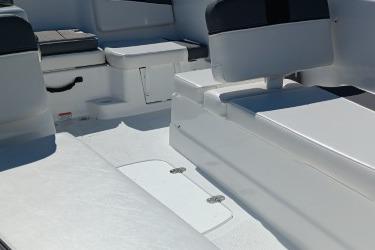 Interior view of 2026 Tahoe T16 boat, featuring sleek white seating and storage compartments.
