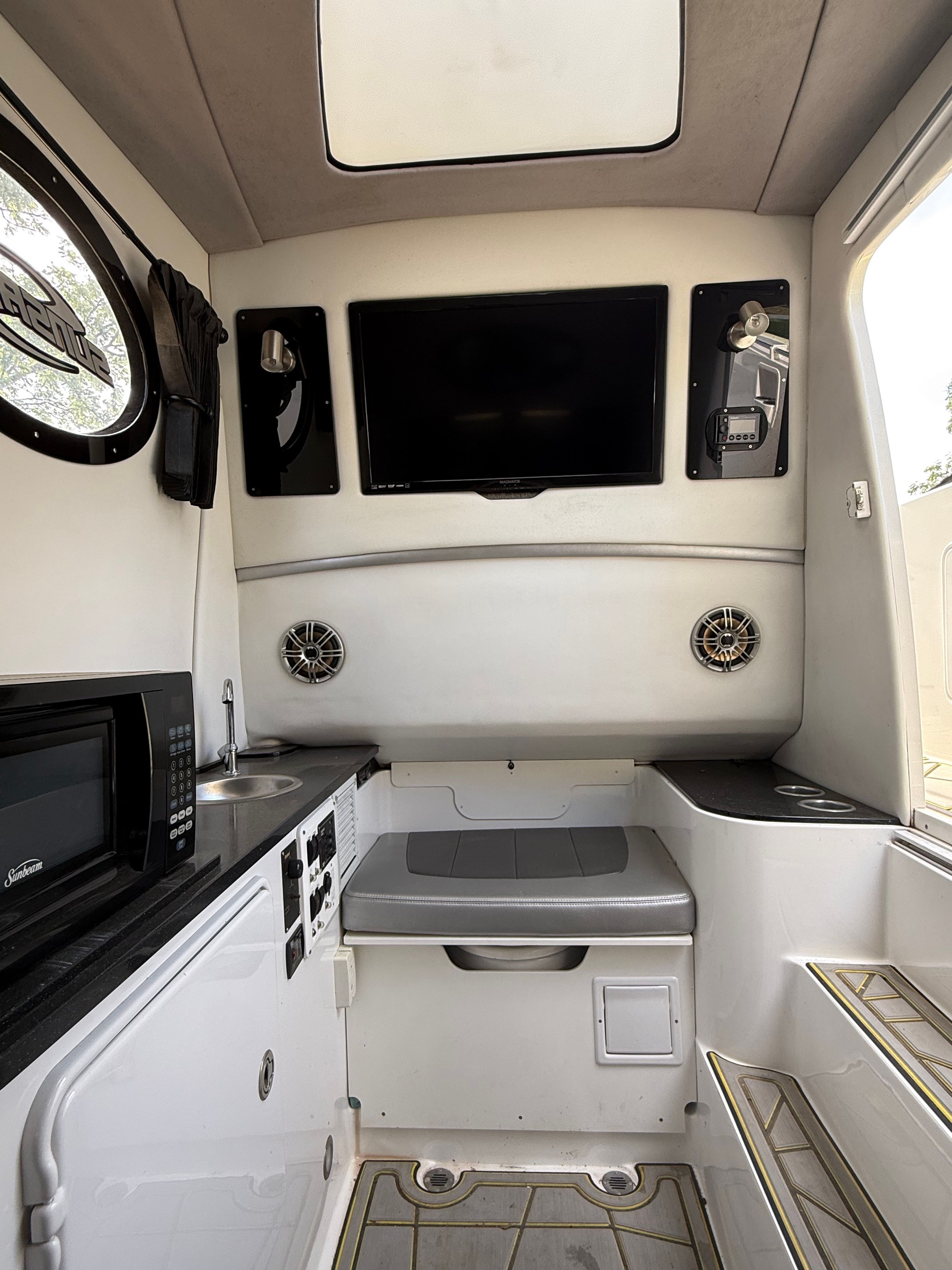 Interior of a 2014 Sunsation 34 CCX with TV, microwave, and seating area.