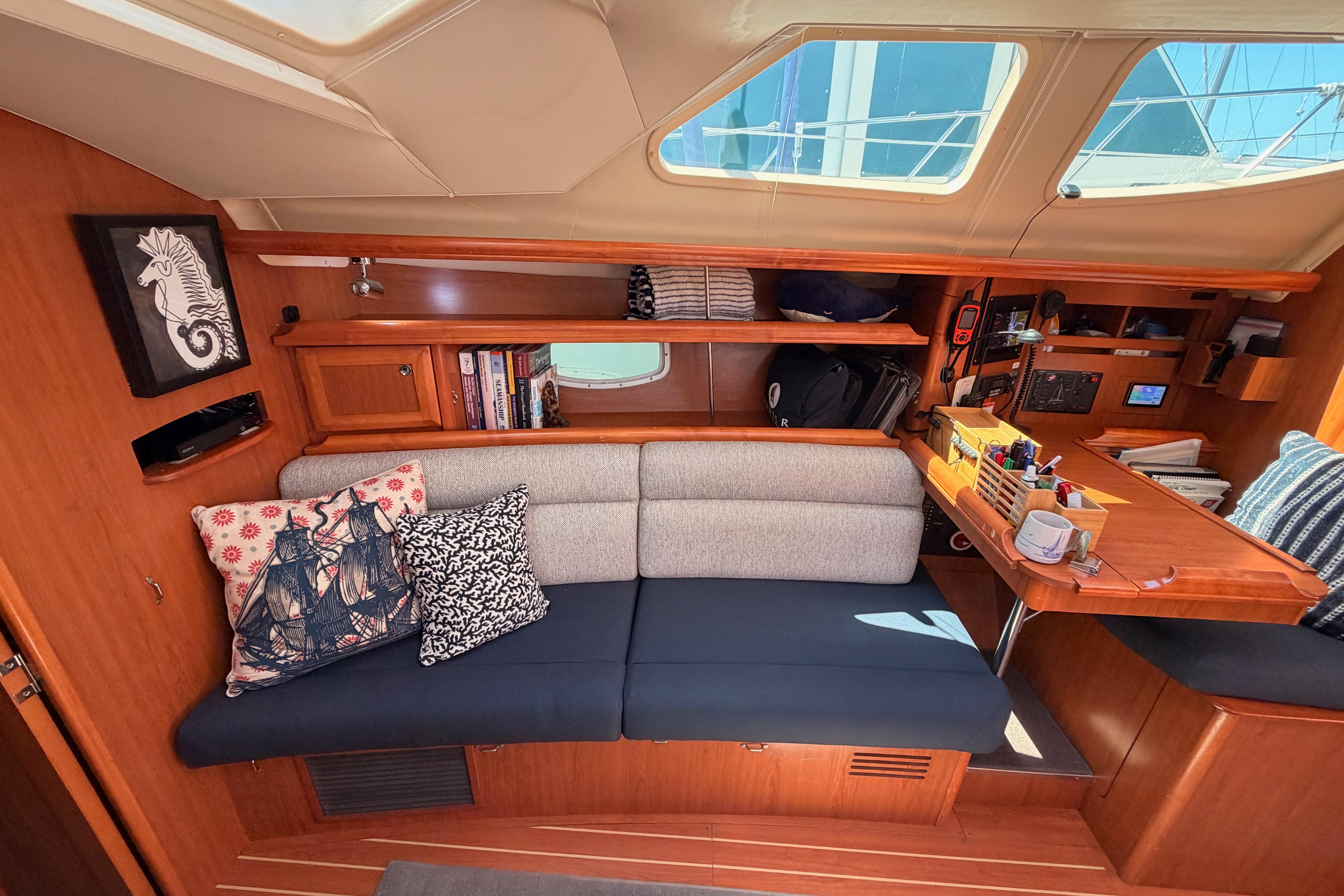 Interior of 2008 Hunter 45 Deck Salon with cozy seating and nautical decor.