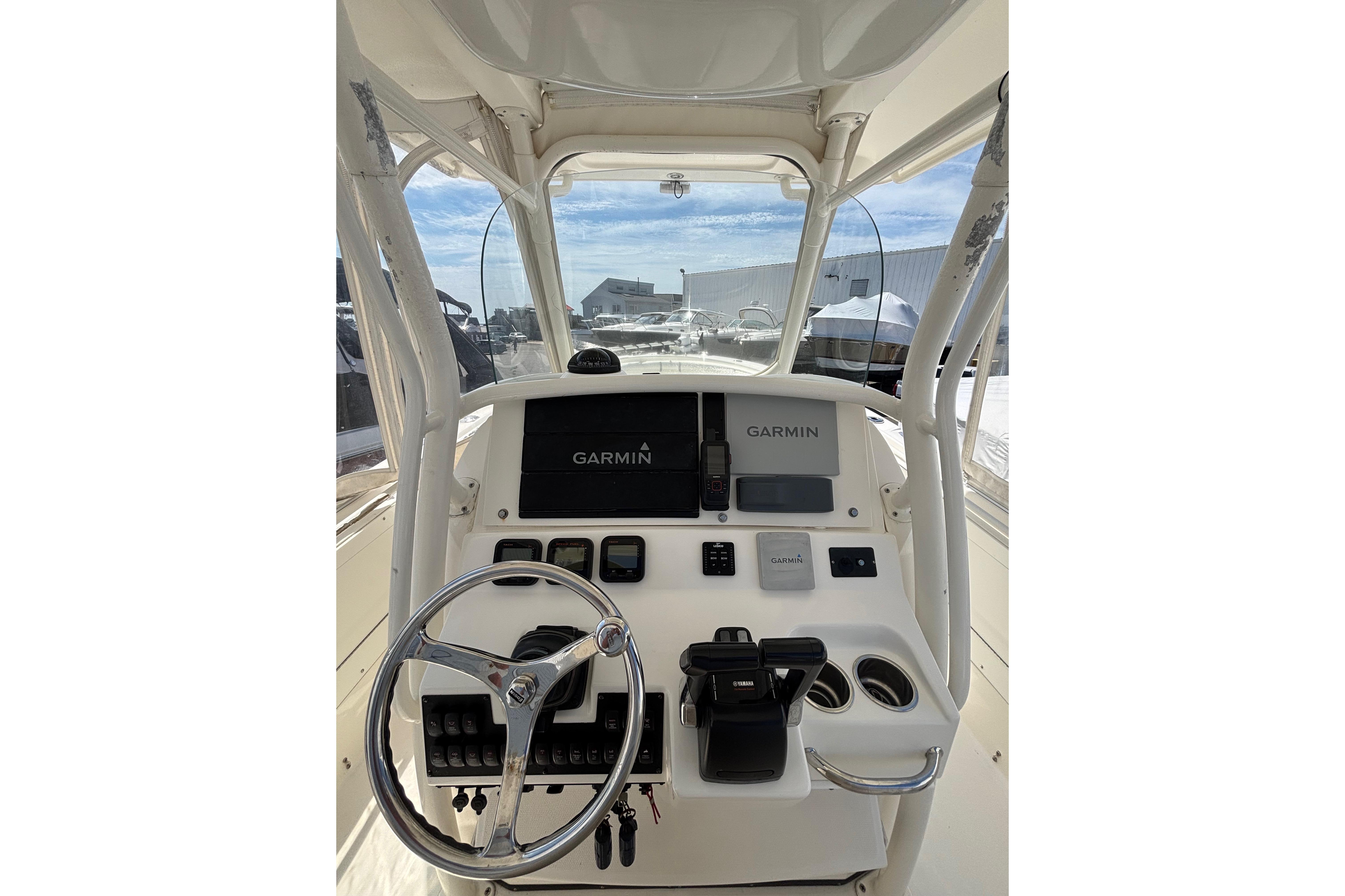 2006 Edgewater 318CC boat dashboard with Garmin navigation system and steering wheel.