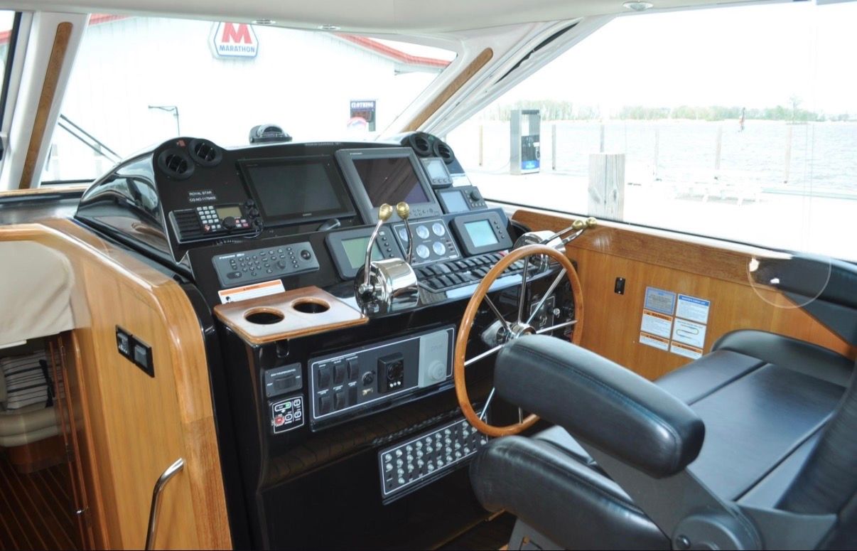 The cockpit of a 2005 Tiara Yachts 5200 Sovran with modern navigation instruments.