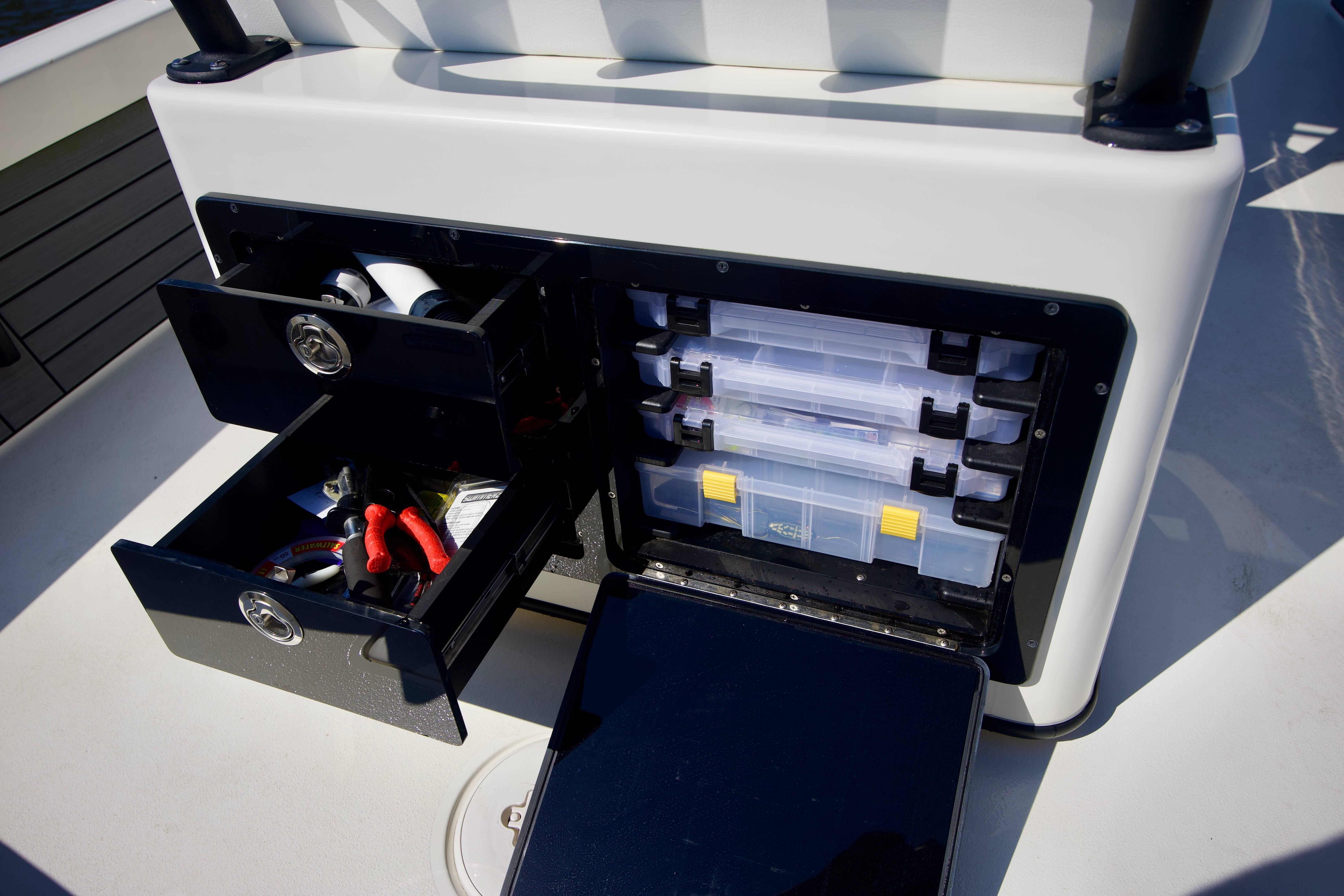 Storage compartments on 2024 Pathfinder 2500 Hybrid boat, featuring organized drawers and tackle boxes.