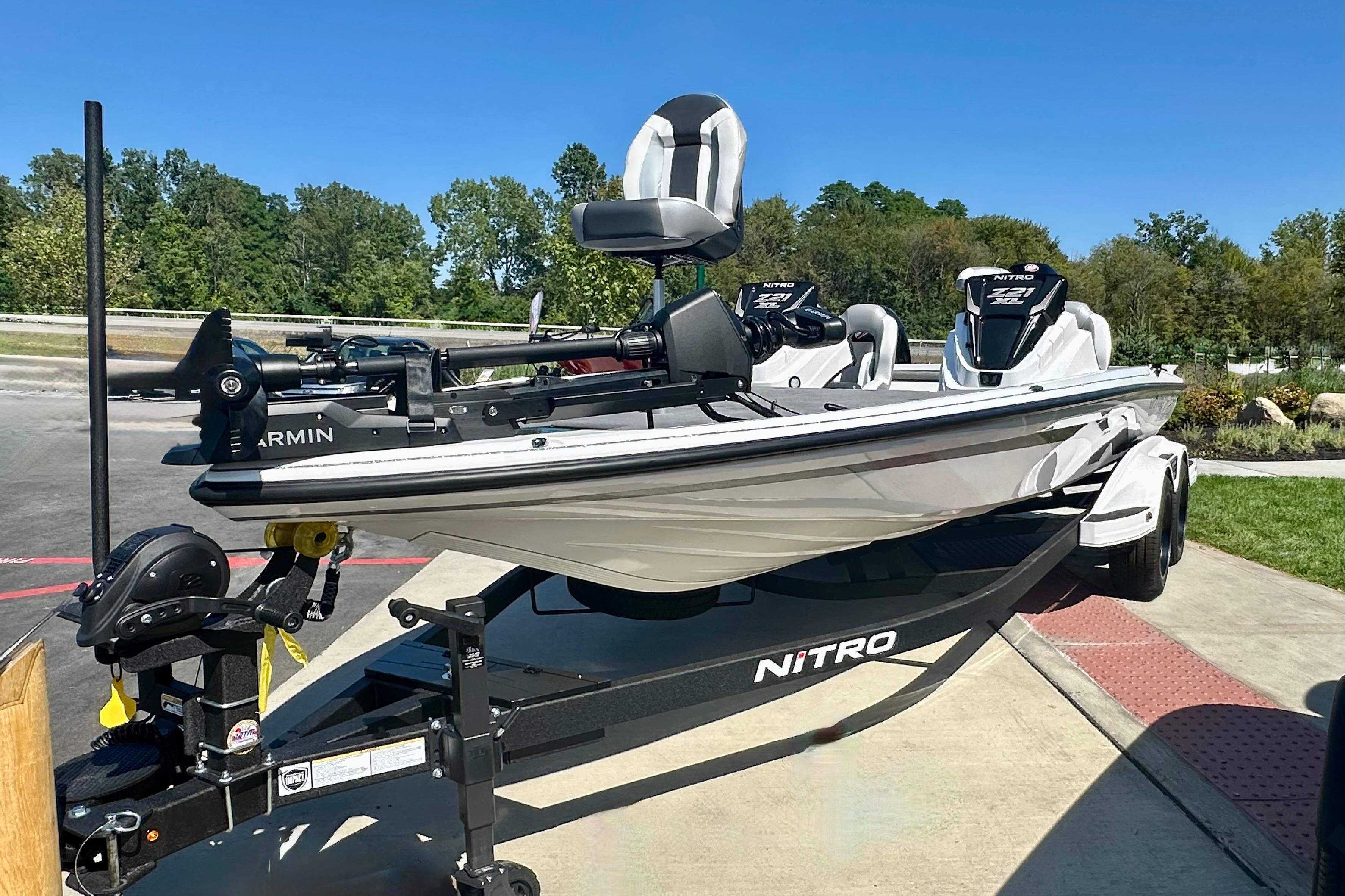 2026 Nitro Z21 XL Pro boat on trailer, parked outdoors under clear blue sky.