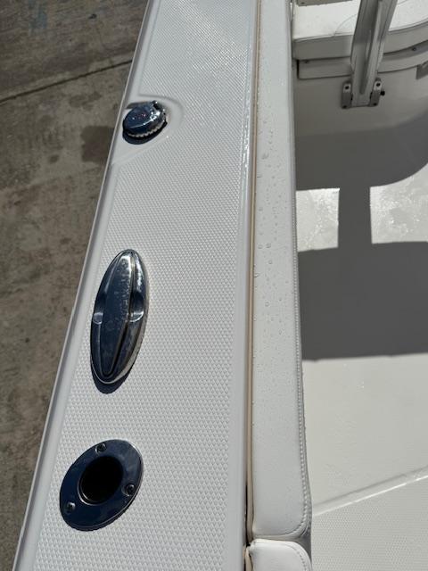 2025 Robalo 266 Cayman boat interior with sleek white seating and stainless steel fixtures.