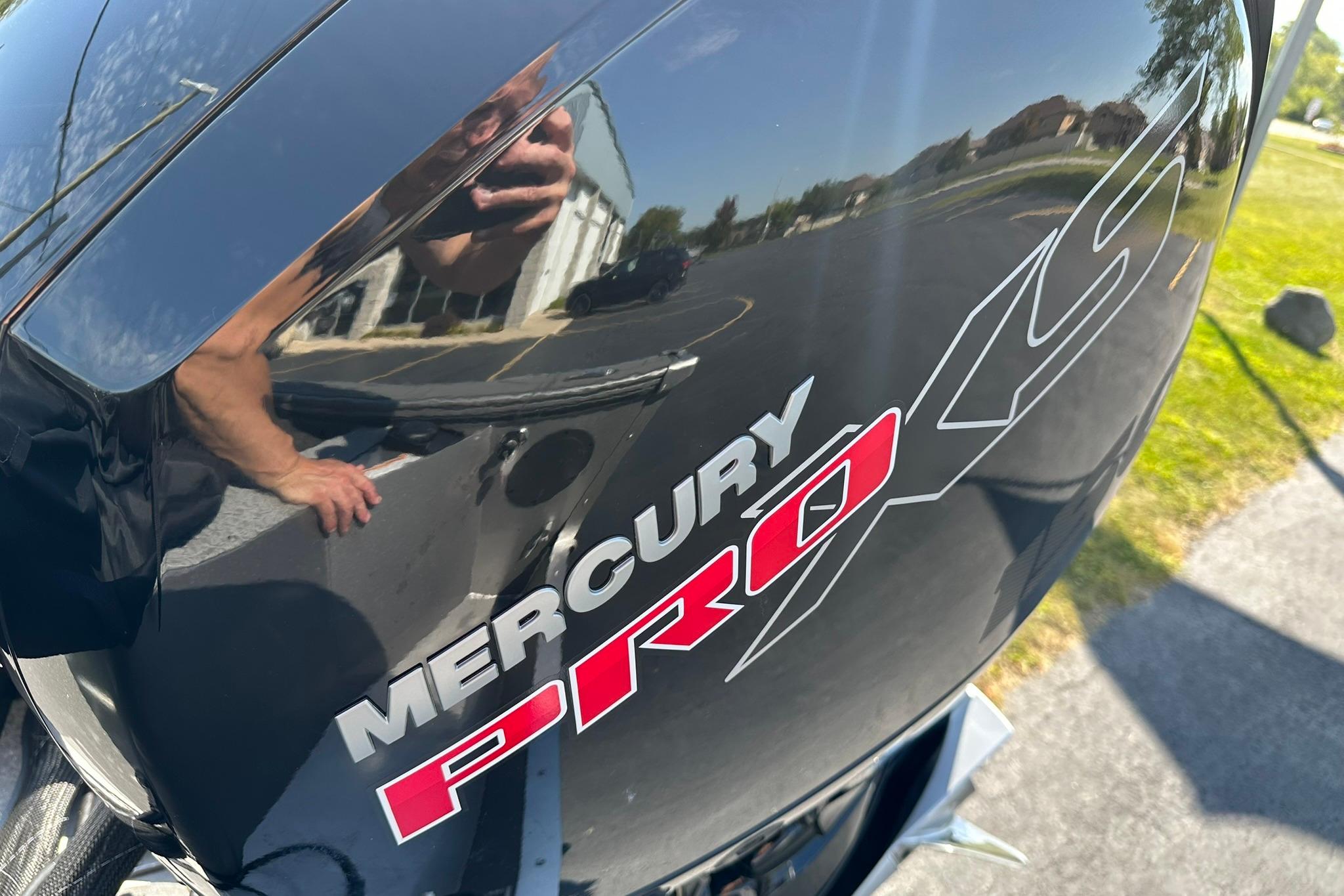 Mercury Pro XS engine on 2026 Lund 1875 Fisherman boat, reflecting surroundings.