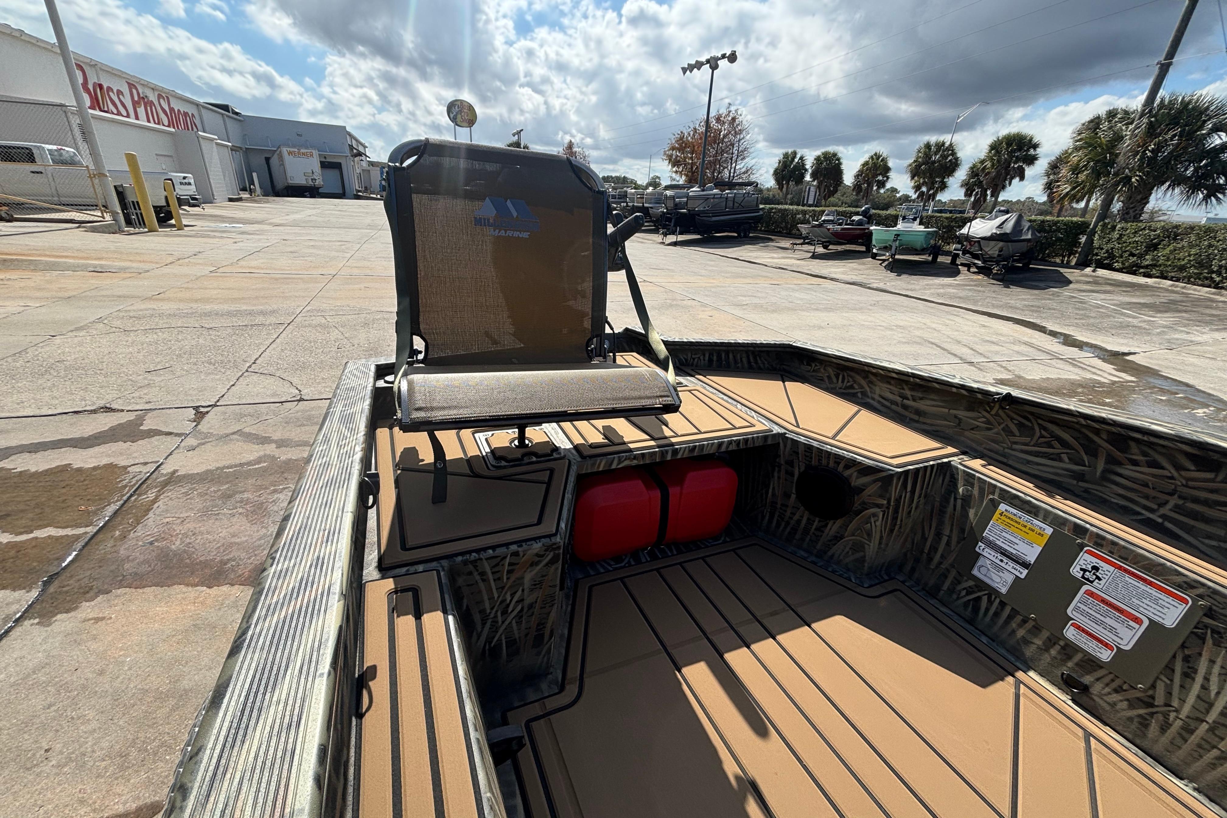 2026 Tracker Grizzly 1650 T Prairie Wings Edition boat at Bass Pro Shops parking lot.