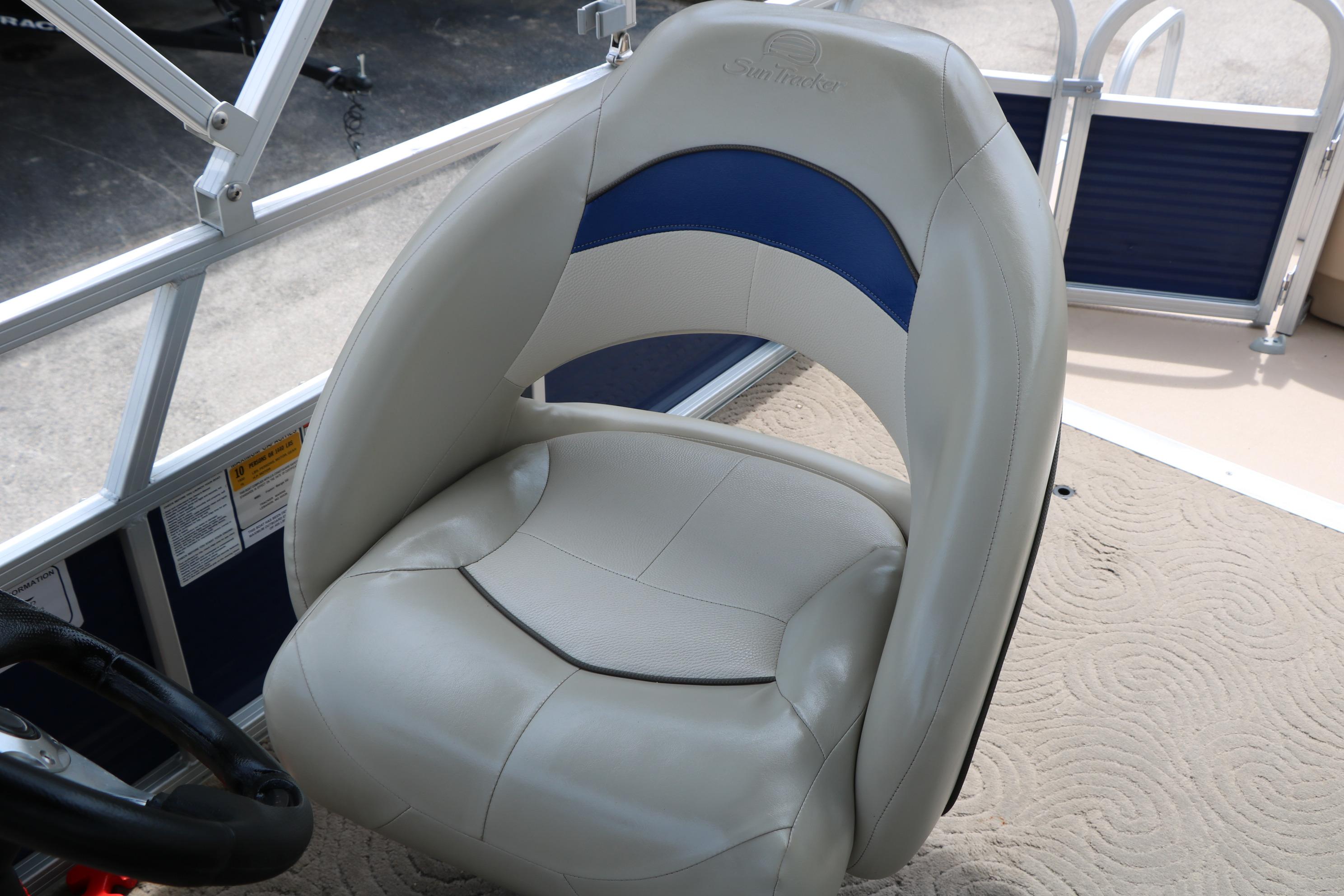 2013 Sun Tracker Fishin' Barge 20 DLX boat seat with blue and beige upholstery.