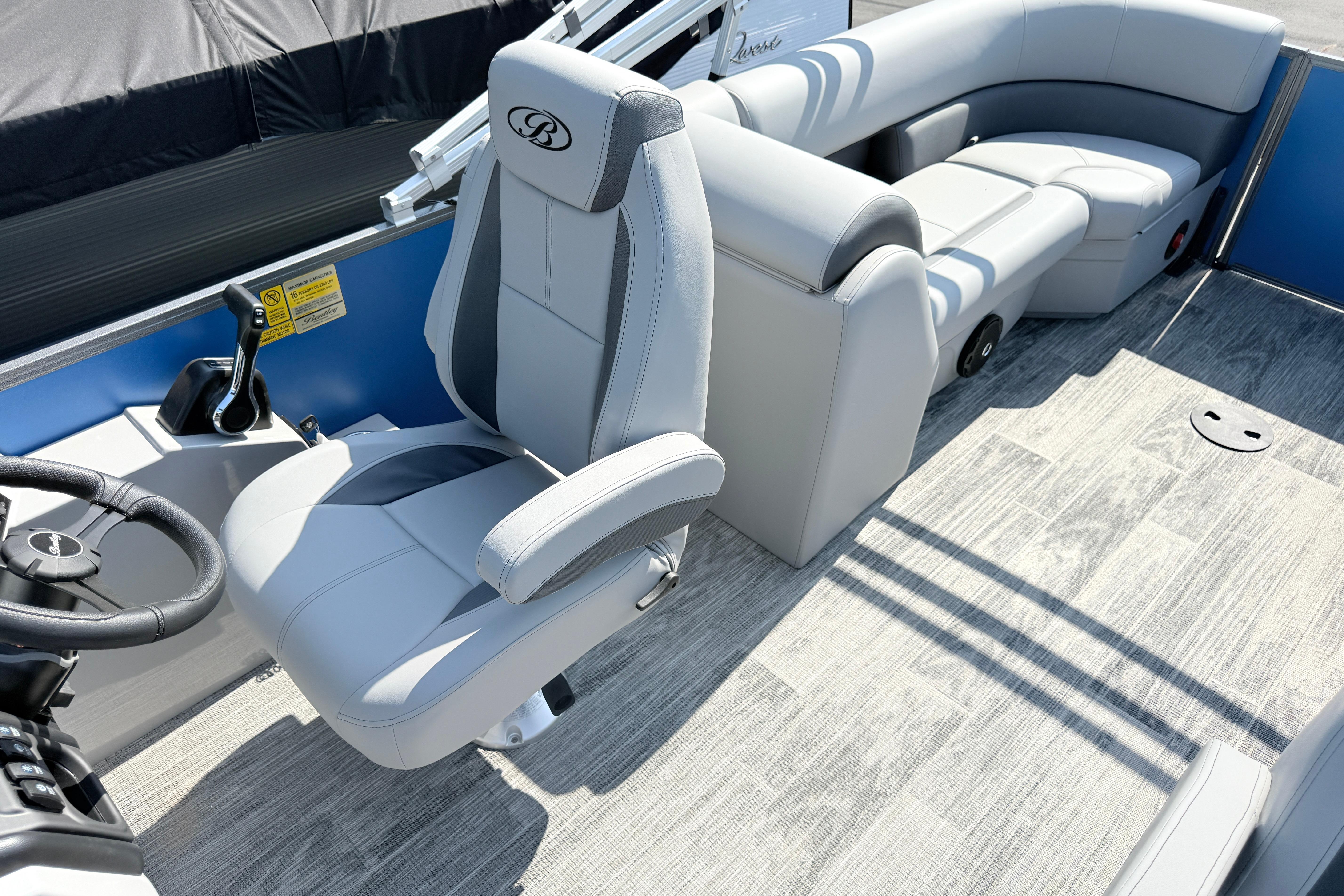 2027 Bentley Pontoons Legacy 240 Navigator interior with plush seating and modern steering.