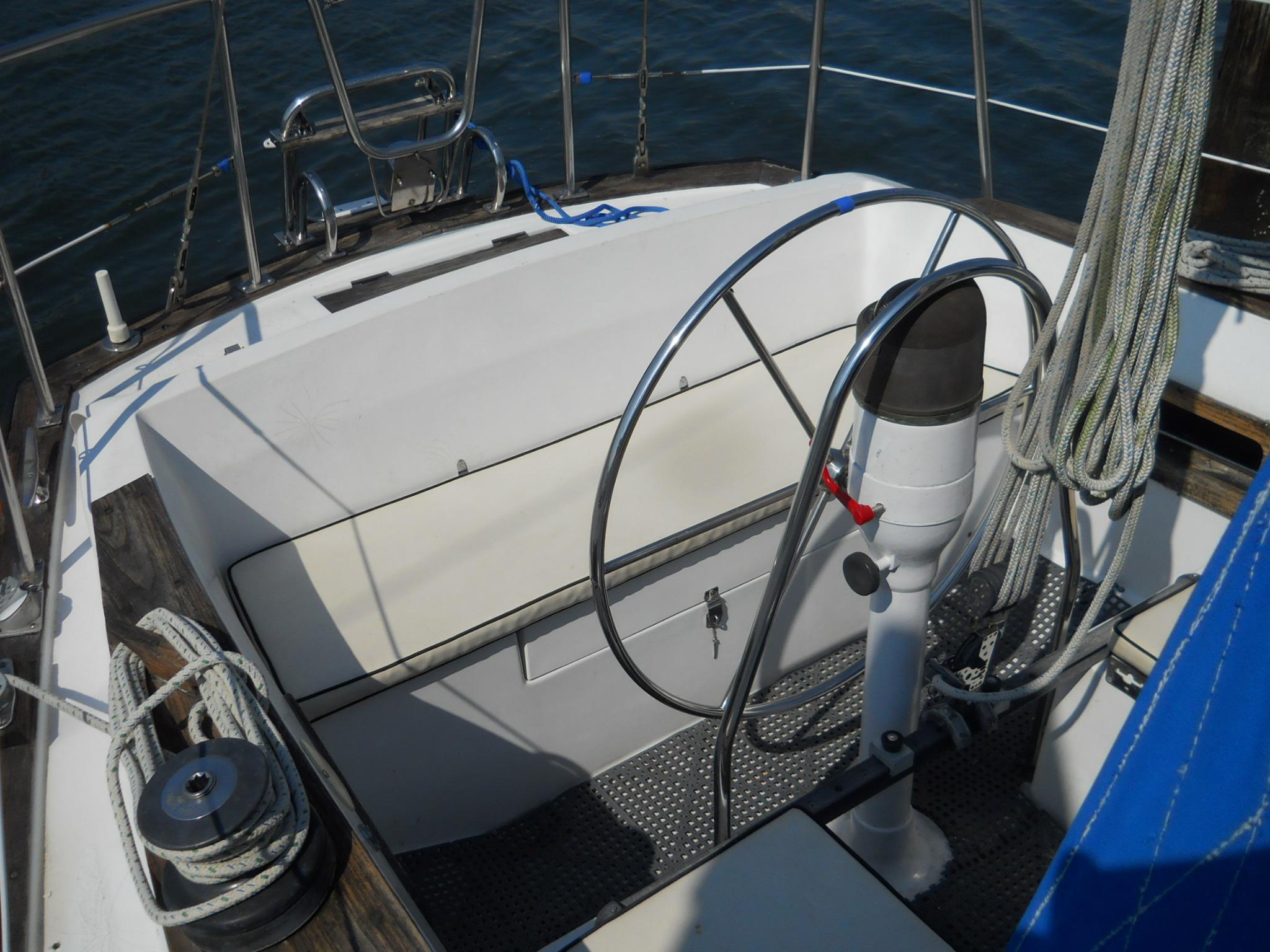1979 Morgan 382 sailboat cockpit with steering wheel and ropes, showcasing nautical design.