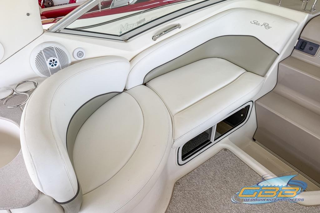 2006 Sea Ray Sundancer 260 interior seating with white upholstery and speaker detail.