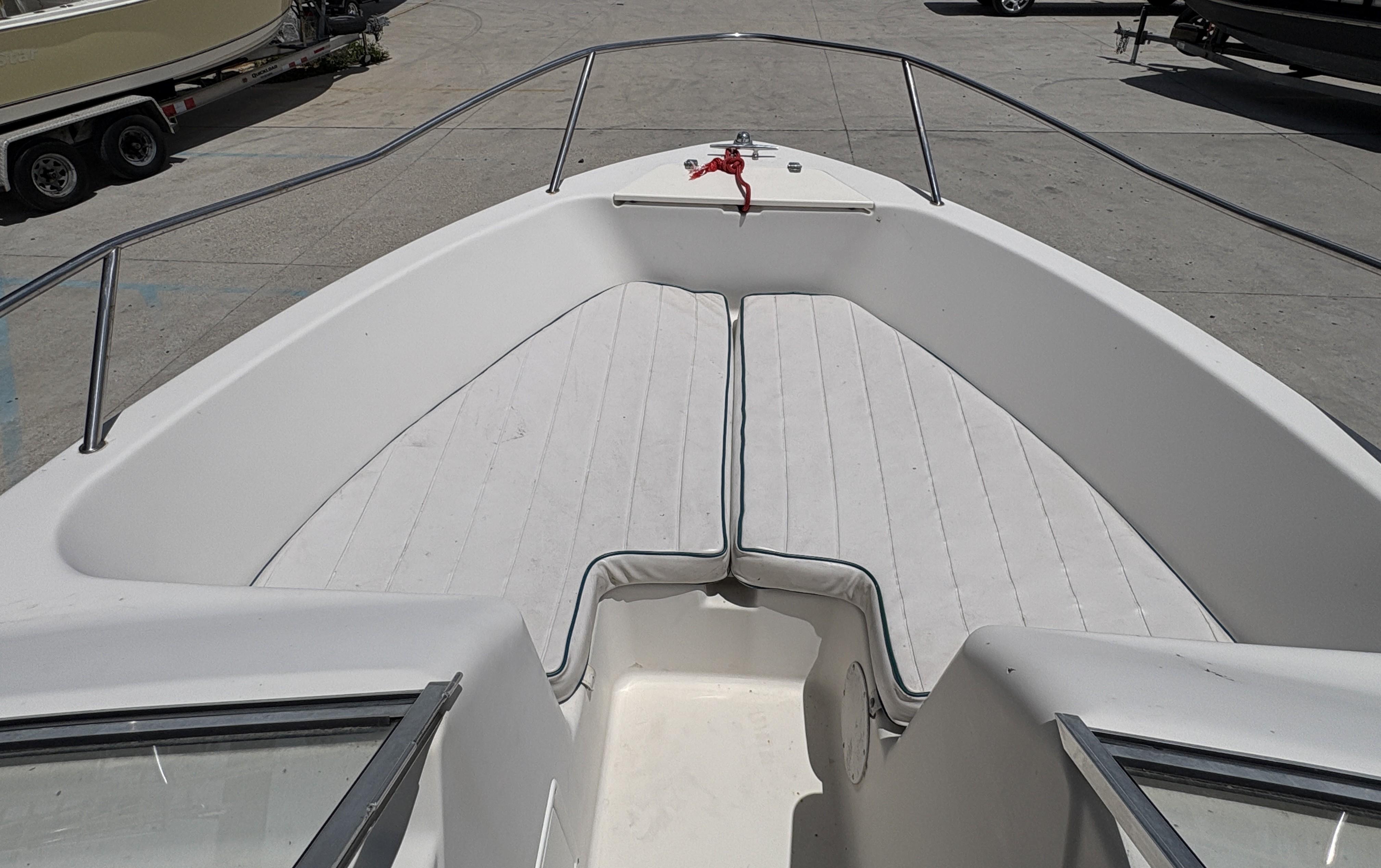 1996 Pro-Line 202 boat interior with cushioned seating and railing.