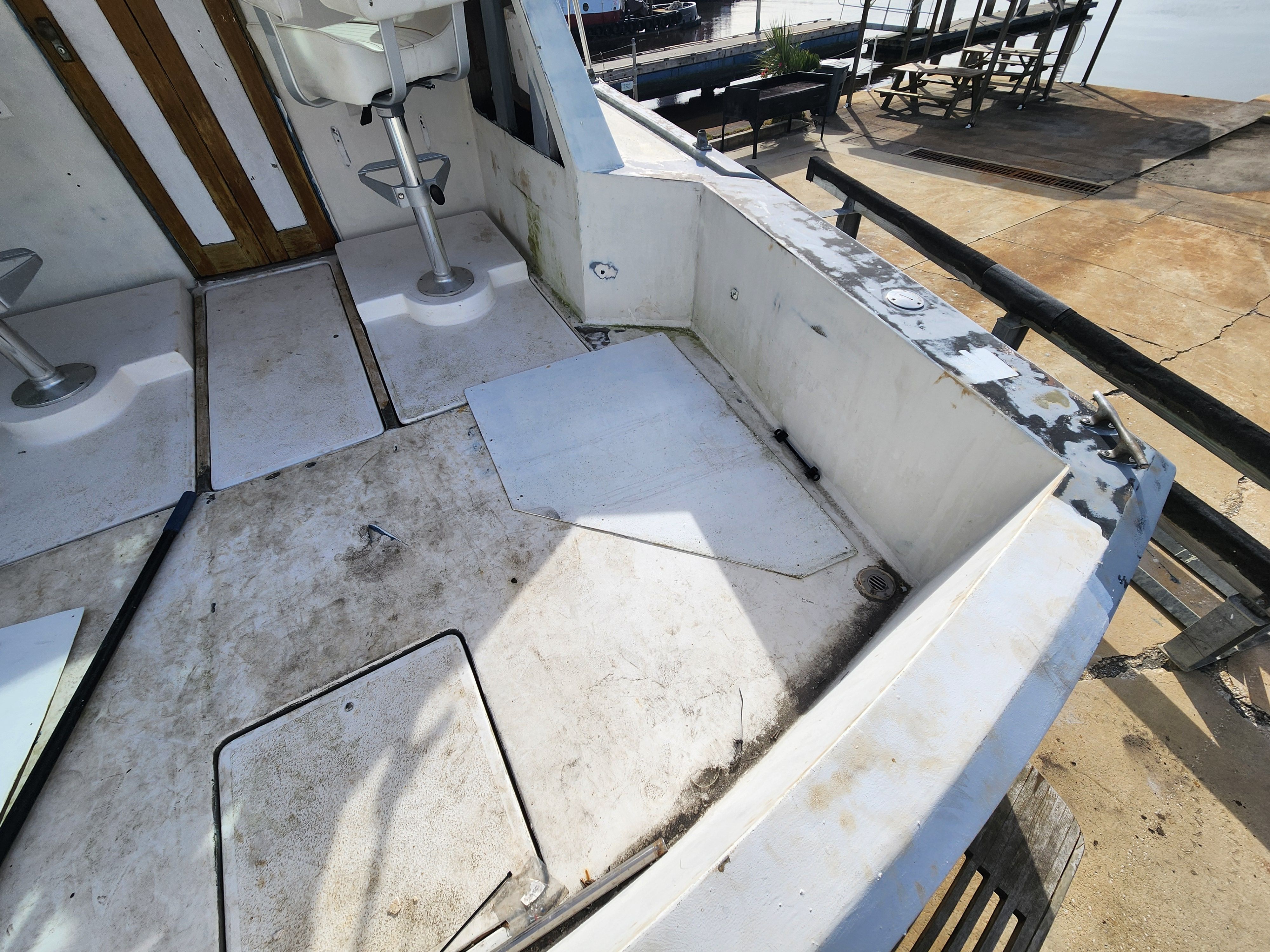 Interior of a 1967 Hatteras 28ft boat showing worn deck.