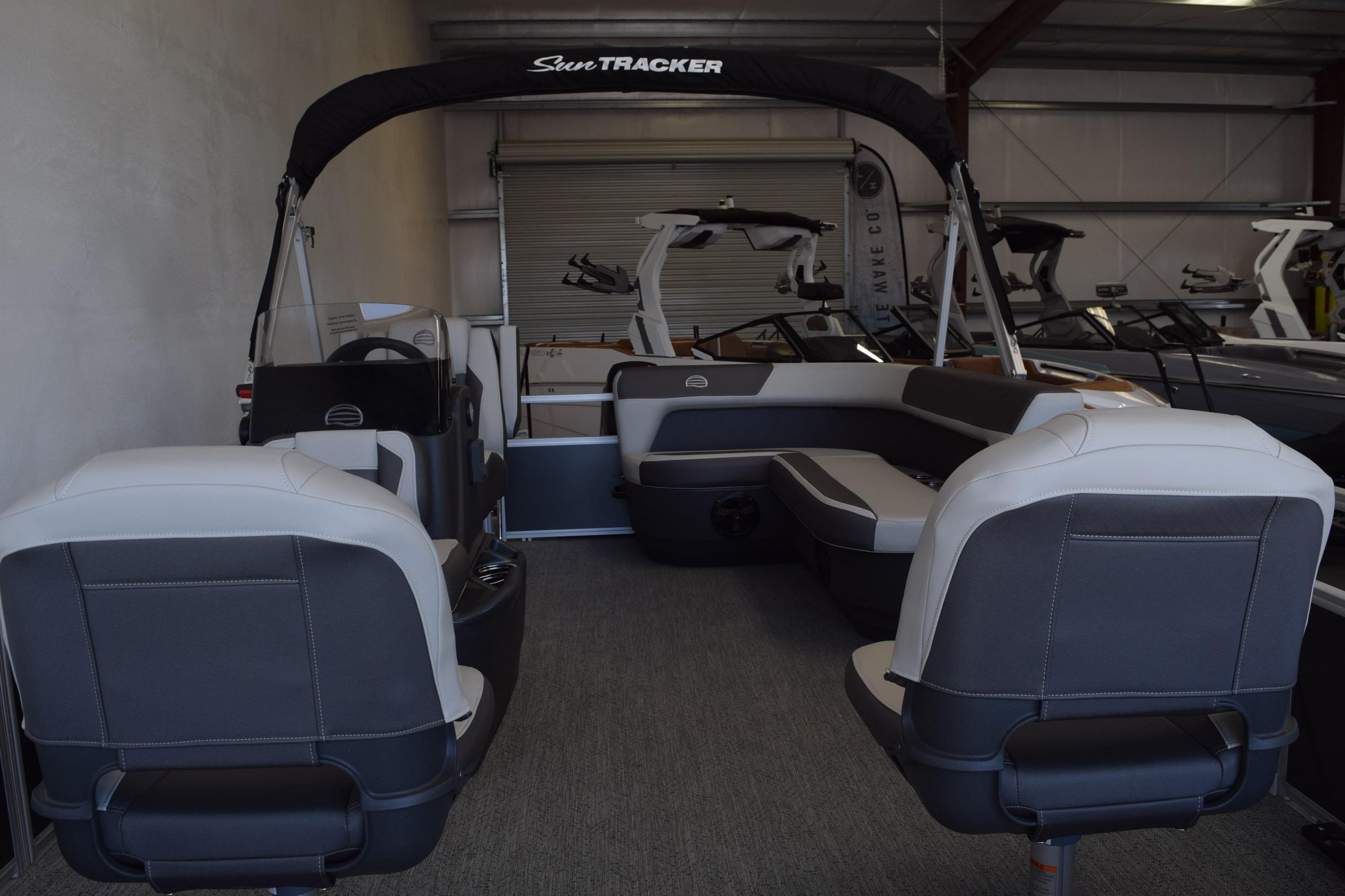 2026 Sun Tracker Bass Buggy 16 XL Select pontoon boat interior in showroom.