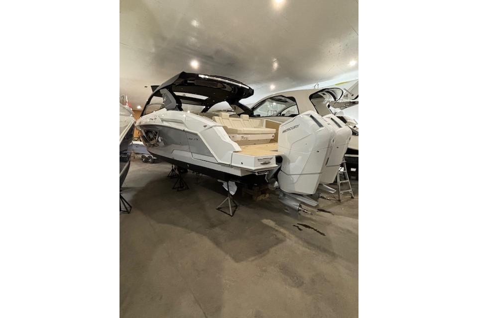 2024 Cruisers Yachts 42 GLS OB in showroom, featuring dual outboard engines.