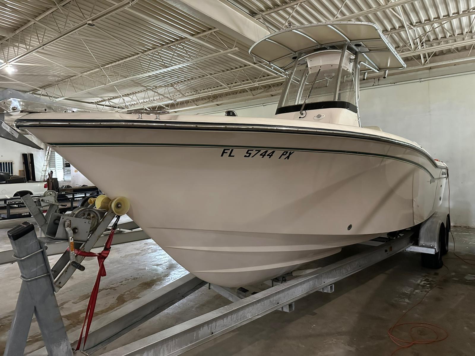 2014 Grady-White Fisherman 257 boat on trailer in indoor storage.