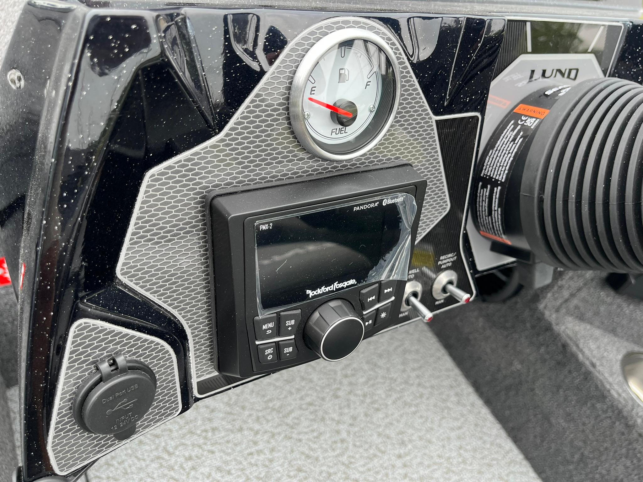 Dashboard of 2026 Lund 1875 Pro-V Bass XS with fuel gauge and audio controls.