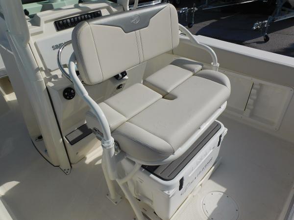 2025 Sailfish 232 CC boat seat with integrated cooler, featuring white cushioned seating.