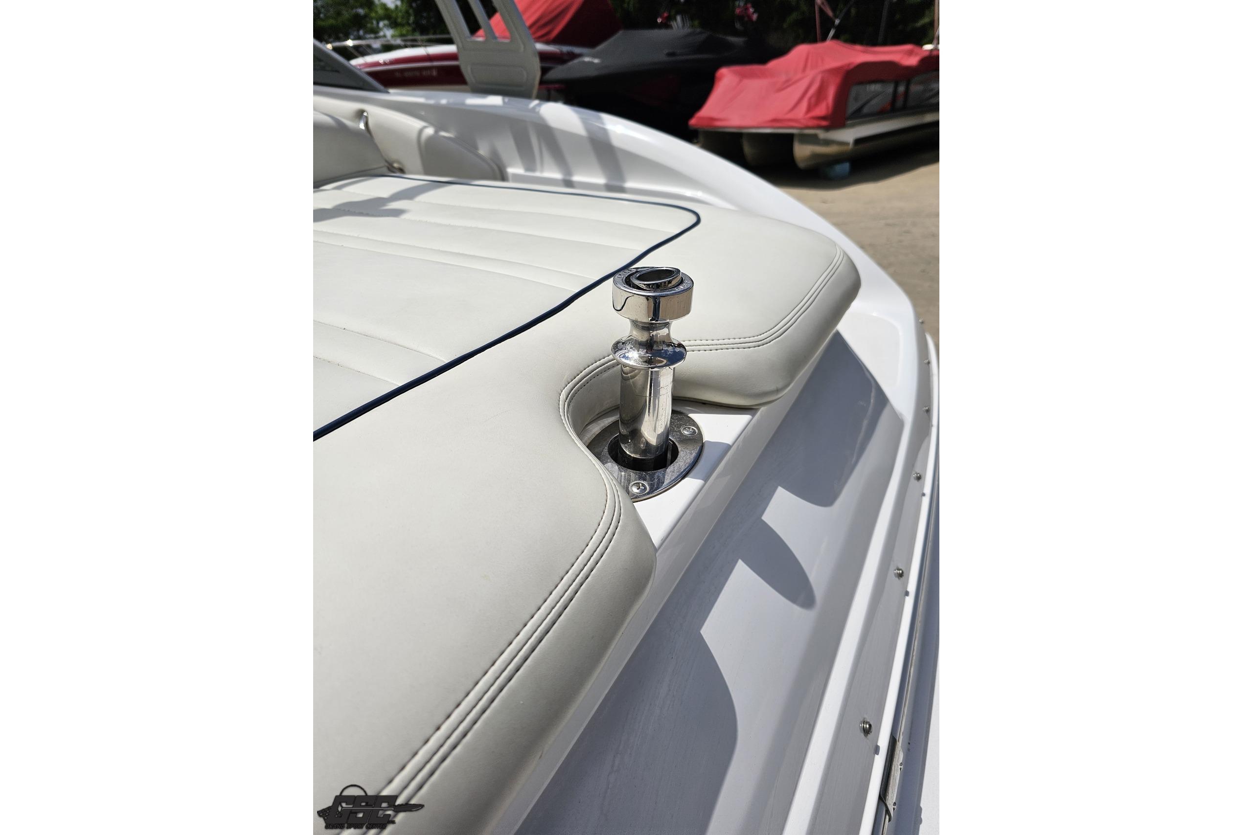 2010 Cobalt 232 WSS boat with white leather seating and chrome hardware.