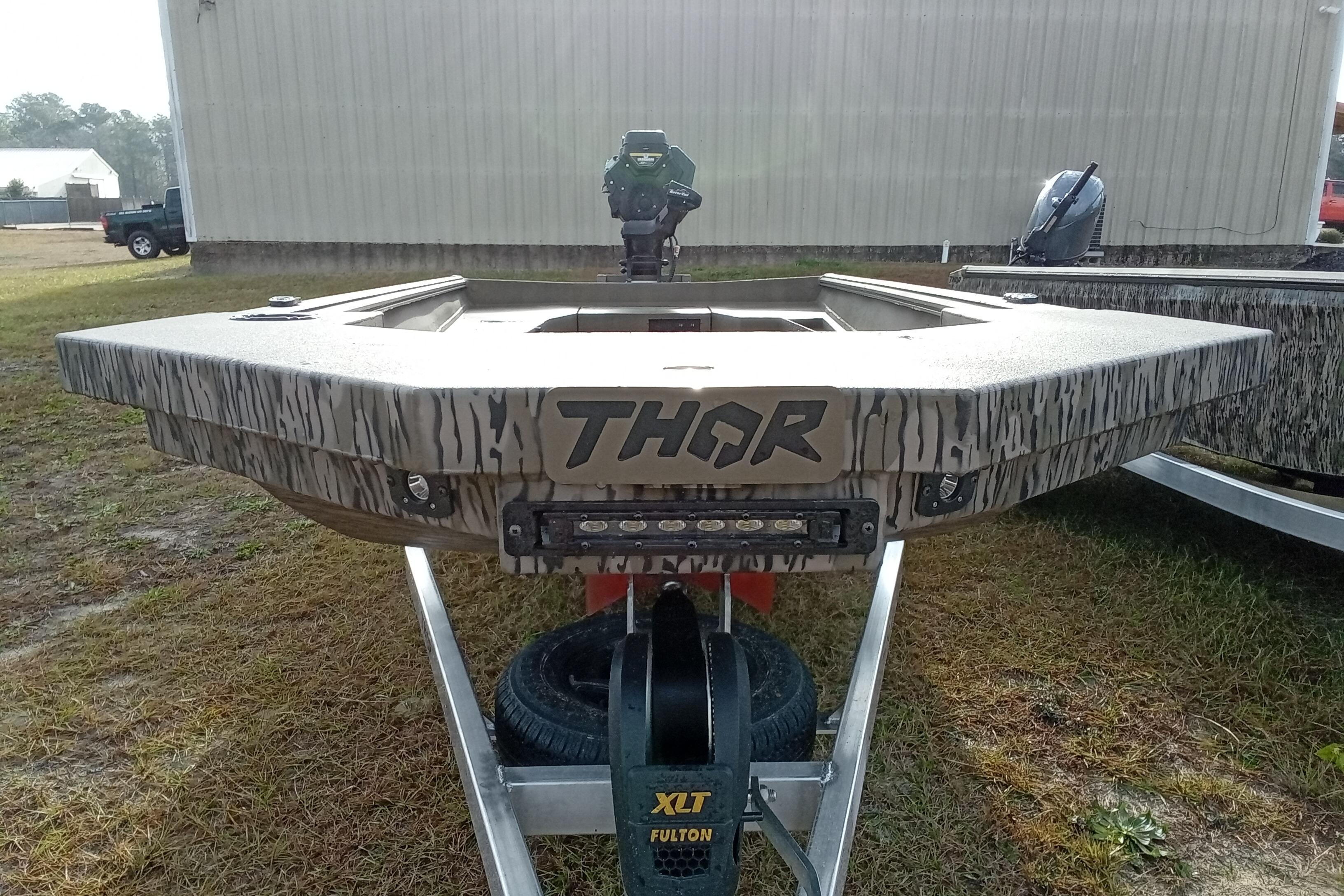 2026 Thor 1754 Swamp Hammer boat on trailer, camo design, outdoor setting.