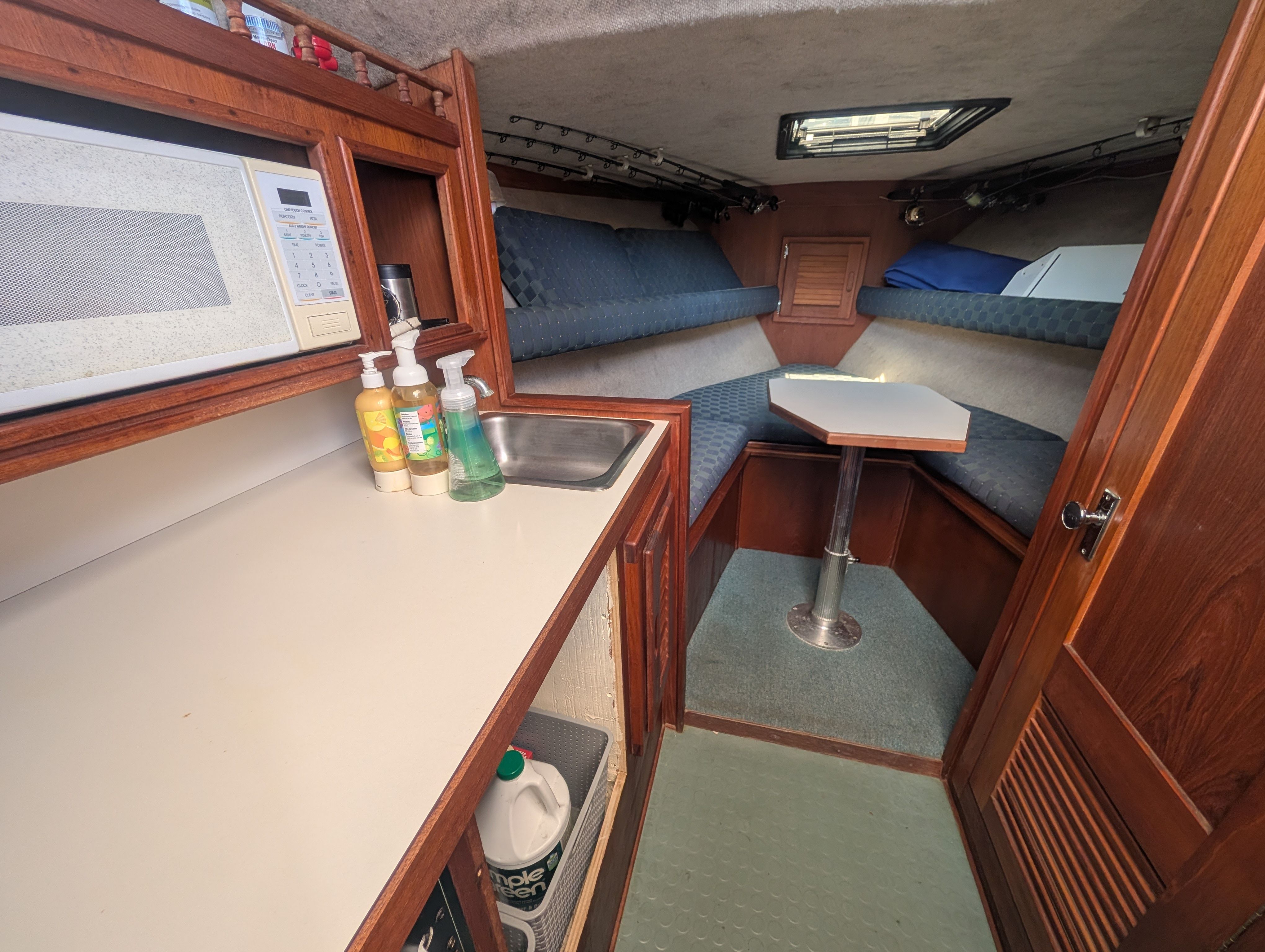 Interior of an Albemarle 265 with kitchenette and seating area.