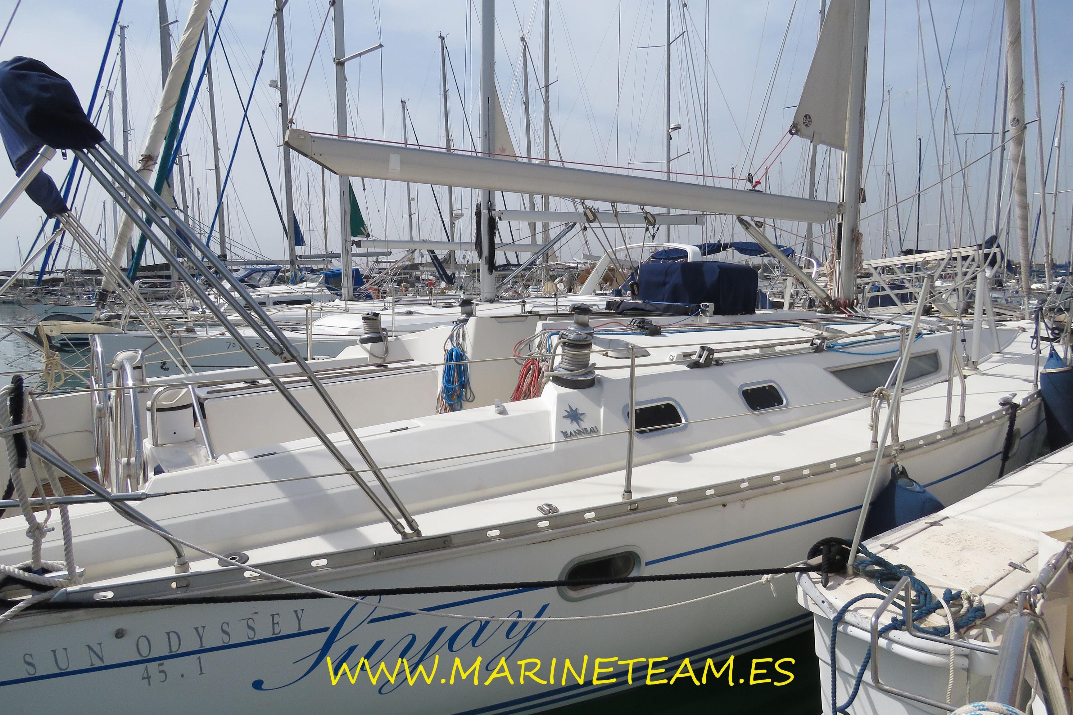 1995 Jeanneau Sun Odyssey 45.1 sailboat docked in a marina, showcasing sleek design and rigging.