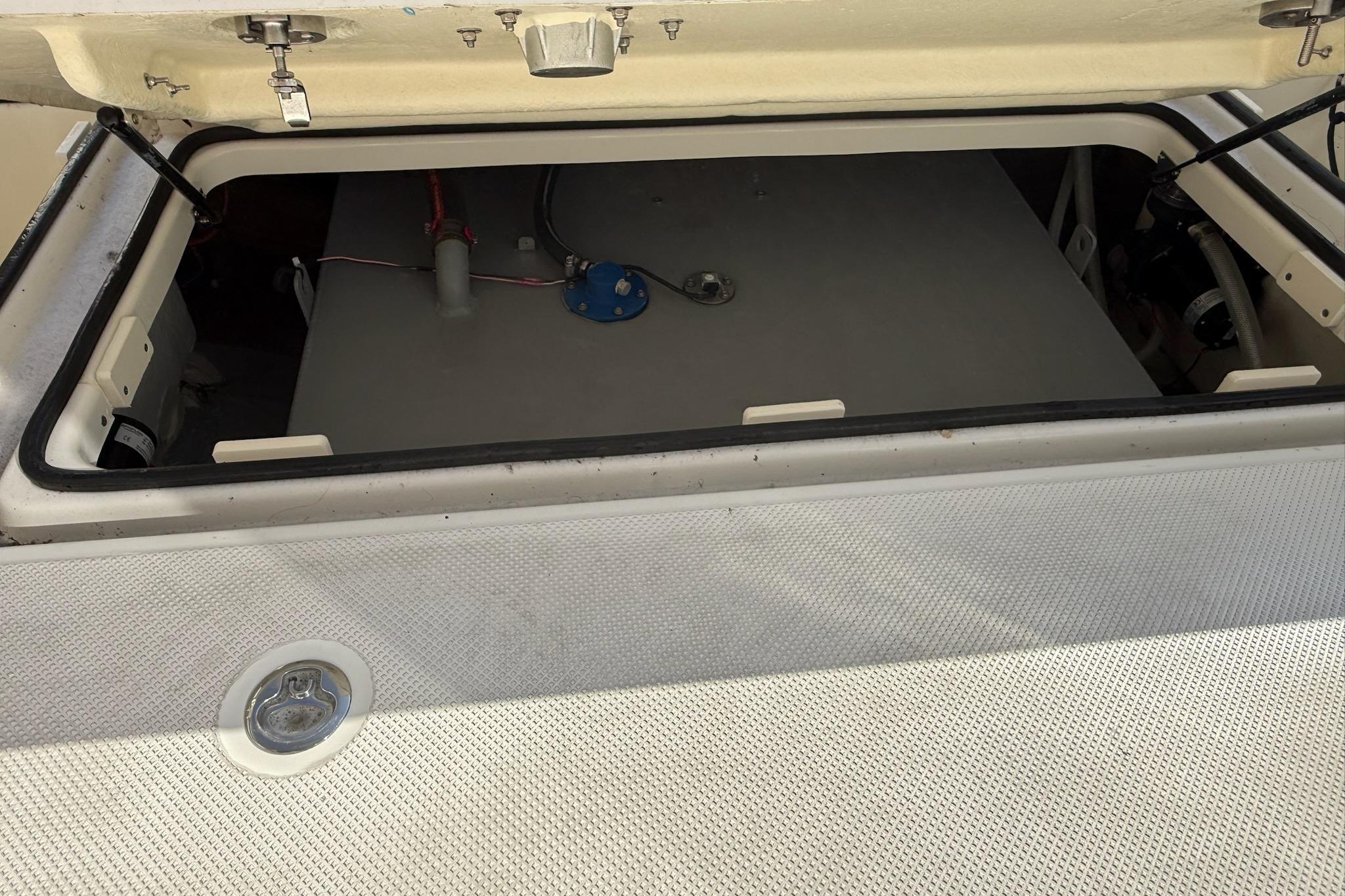 Open storage compartment on 2024 Bayliner Trophy T25 Pilothouse boat.