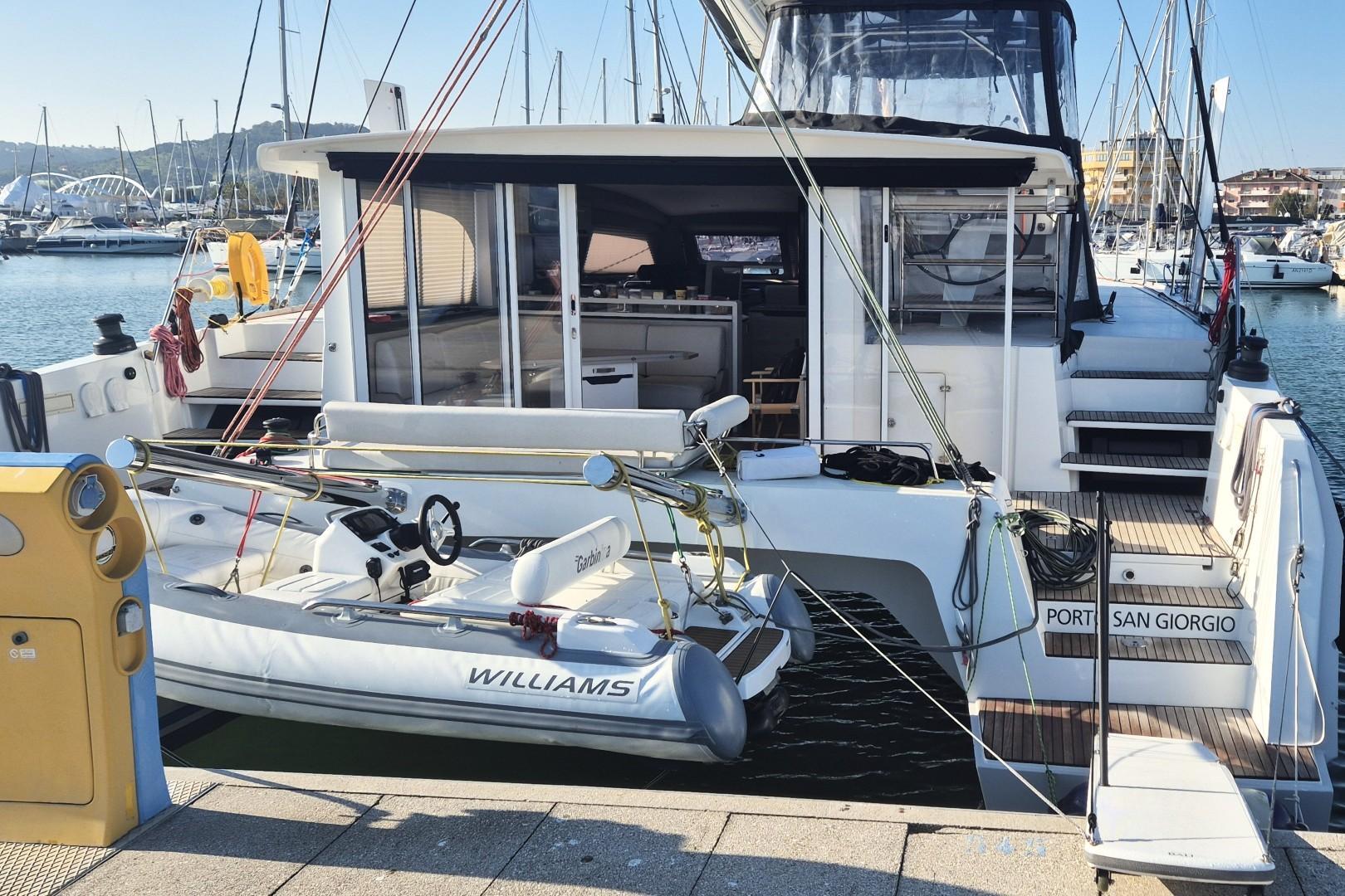 2023 Catana Ocean Class yacht docked with a small tender boat at Port San Giorgio.