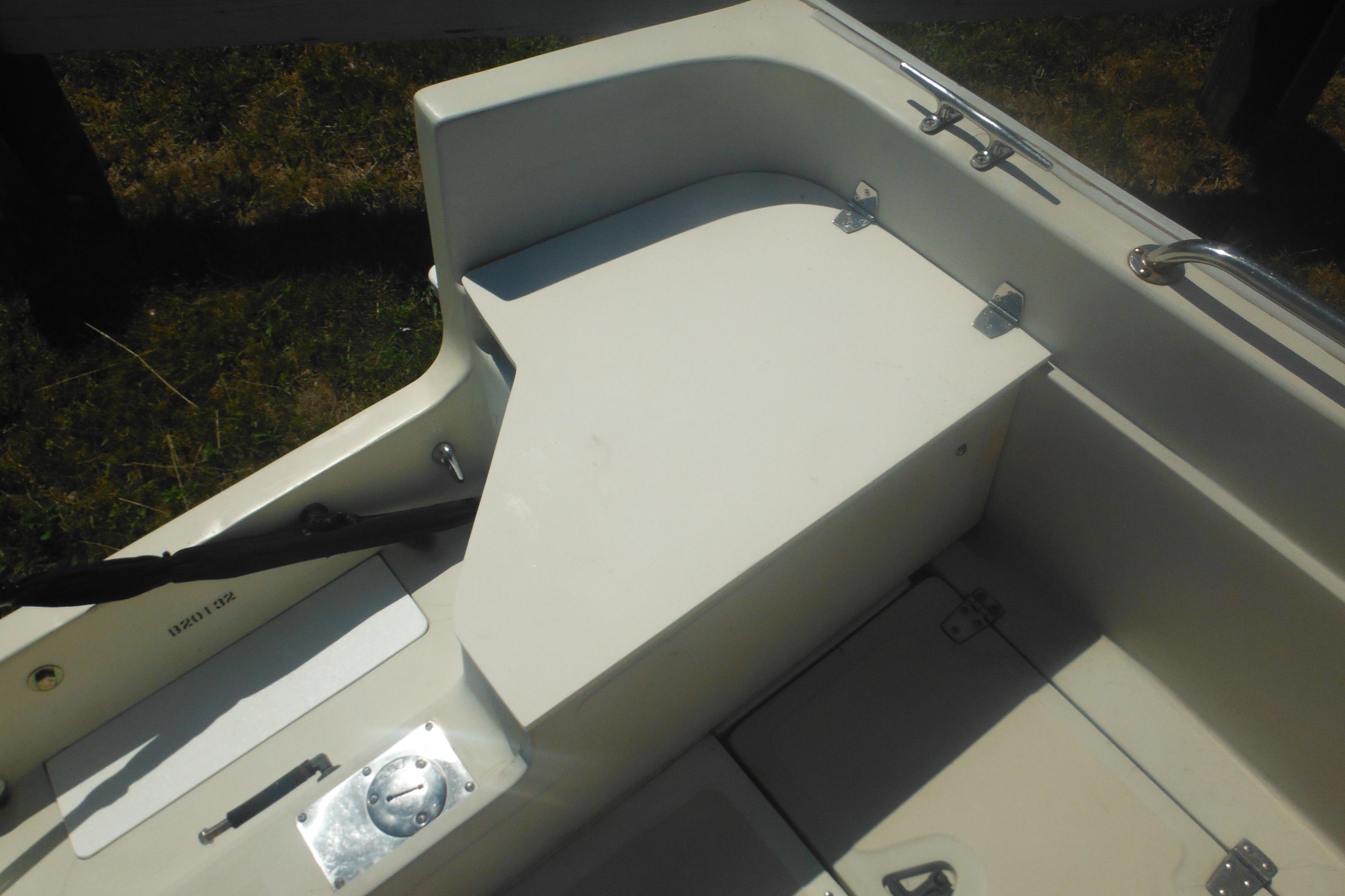 1991 Boston Whaler 16 SL boat interior, featuring storage compartments and seating area.