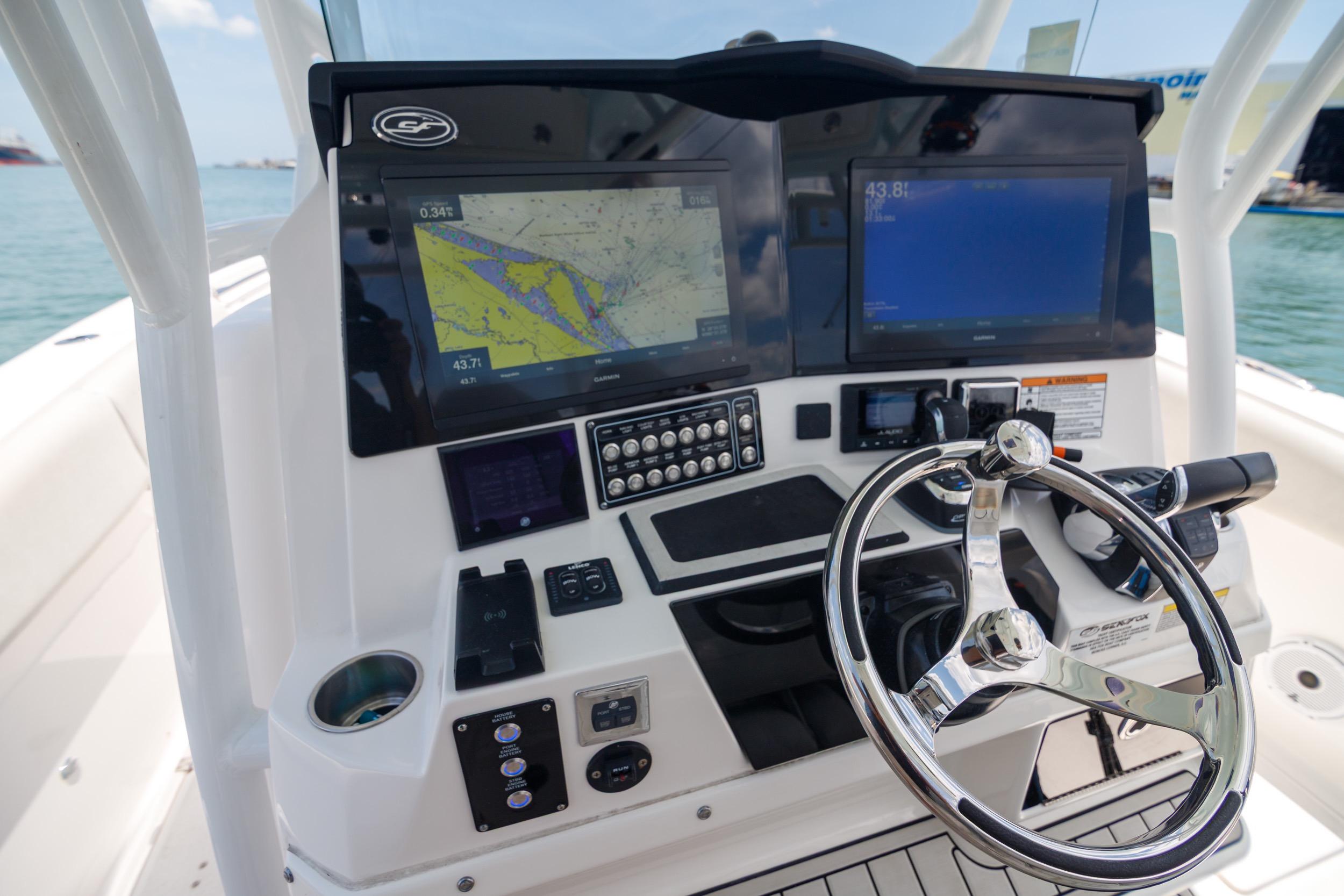 2021 Sea Fox 328 Commander helm with dual displays and steering wheel.