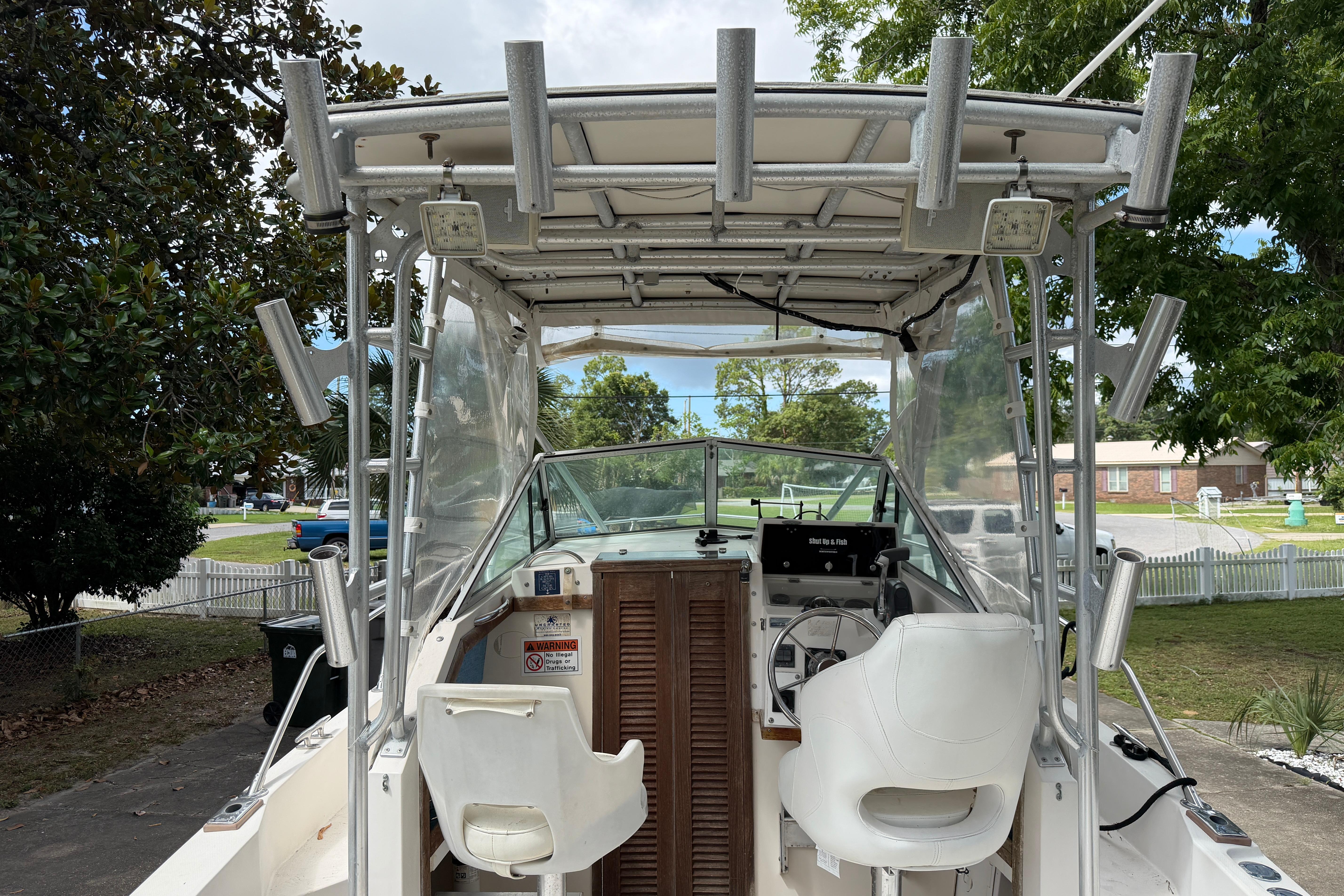 1987 Grady-White Seafarer 226 boat interior with helm and seating, parked outdoors.
