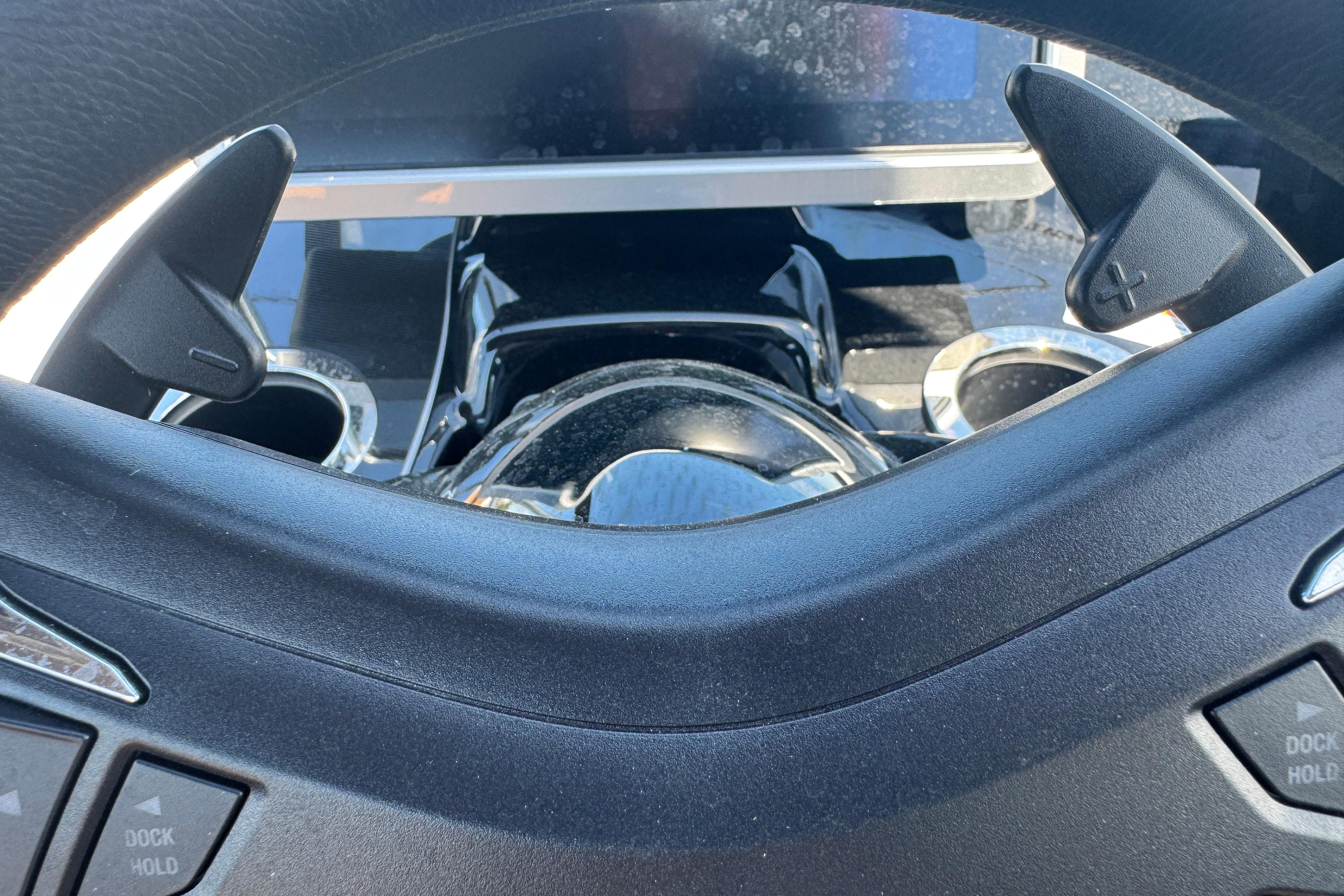 Steering wheel and controls of 2026 Yamaha Boats 252SD, featuring modern design elements.