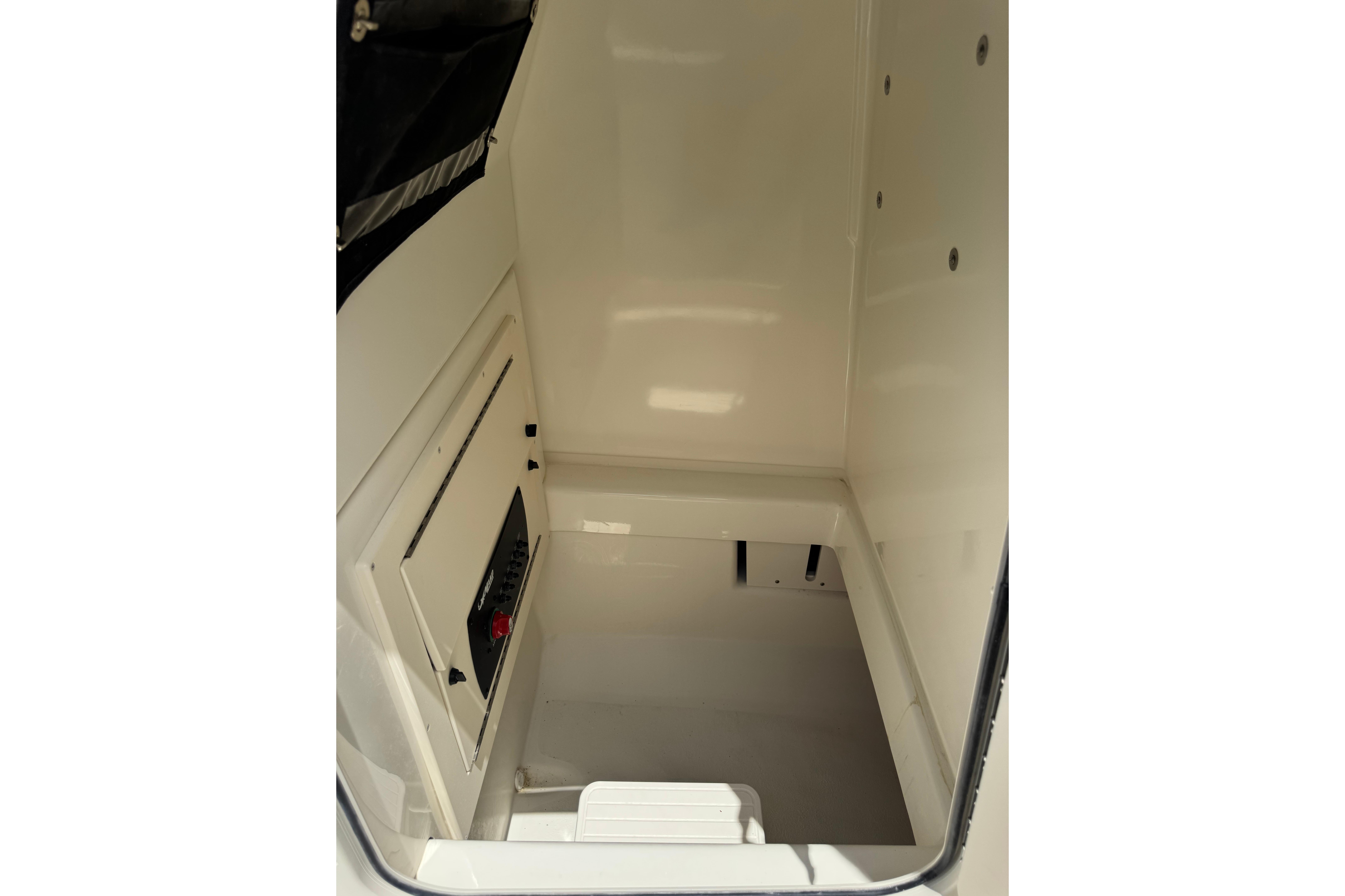 Interior view of 2026 Mako 214 Center Console boat's storage compartment.