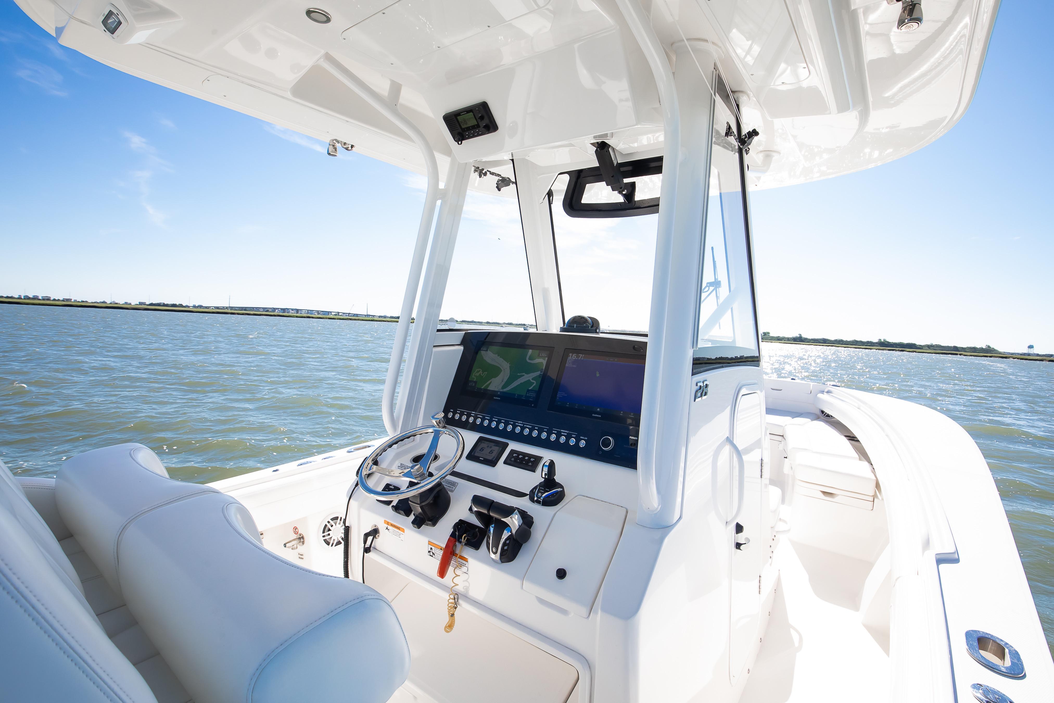 2022 Regulator 28 Forward Seating boat interior with helm, on a sunny day at sea.