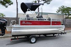 2026 Sun Tracker Bass Buggy 16 XL Select pontoon boat on trailer.
