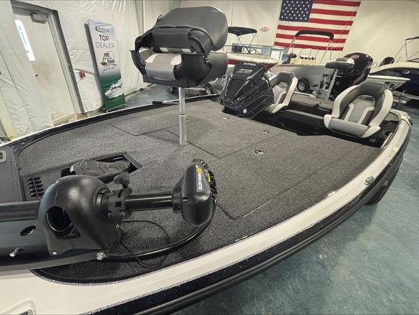 2025 Nitro Z18 boat interior with seating and equipment, displayed indoors with an American flag.