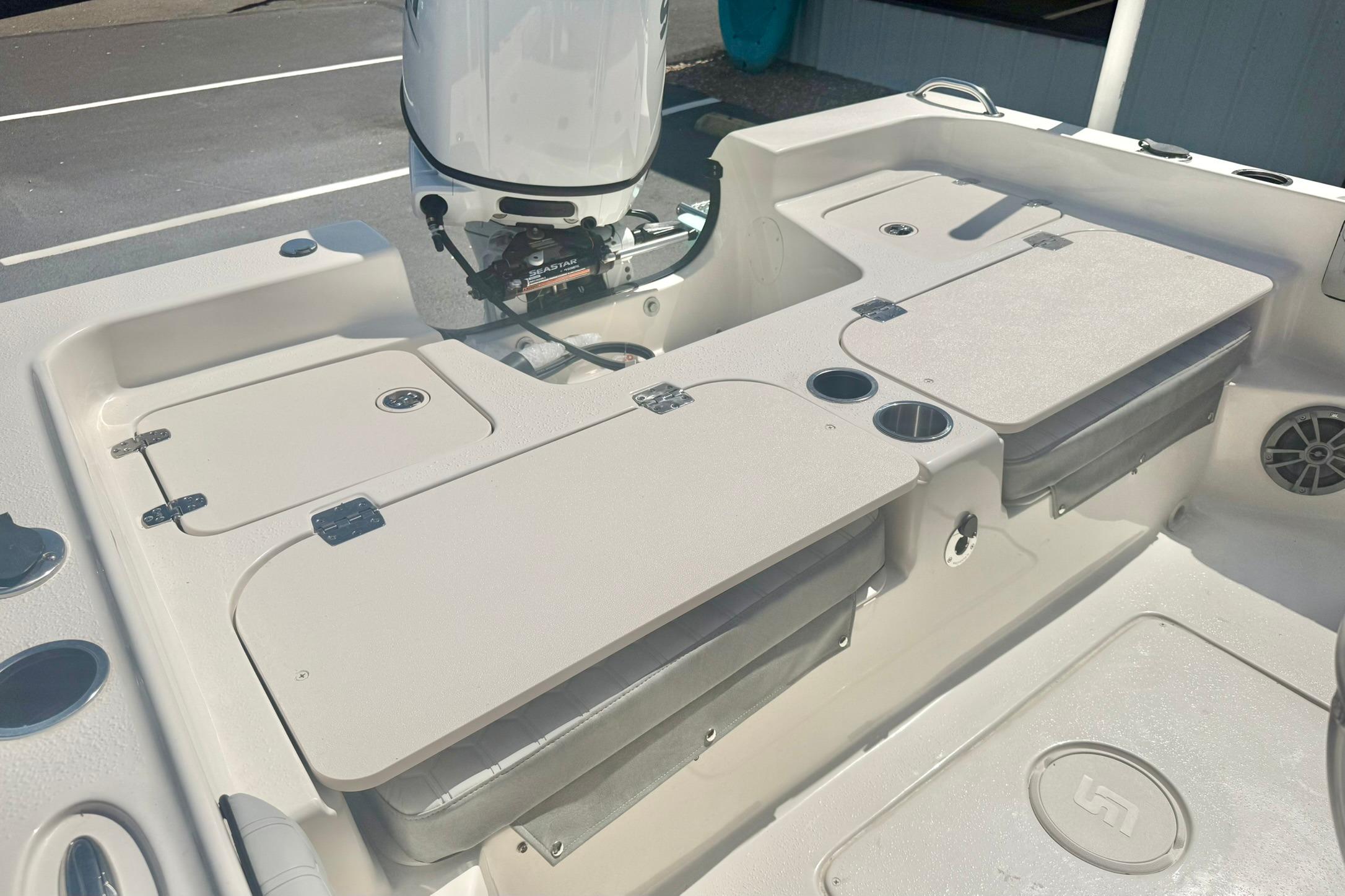 2026 Carolina Skiff 21 Ultra Elite boat interior with storage compartments and motor.