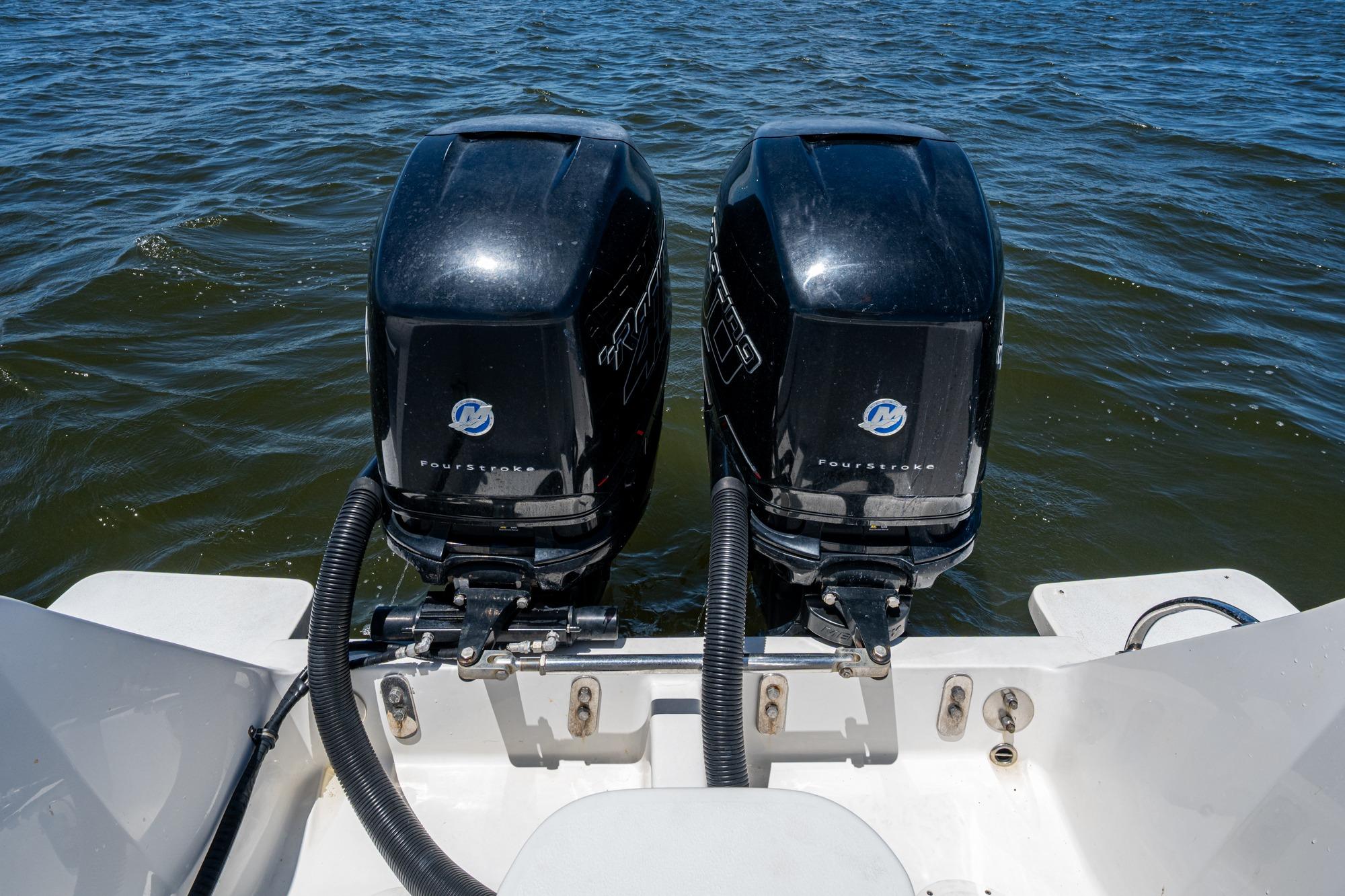 Twin outboard motors on a 2010 Intrepid 323 OPEN boat in open water.