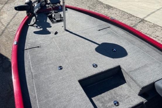 2025 Tracker Savage 215 boat deck with red trim and carpeted surface.